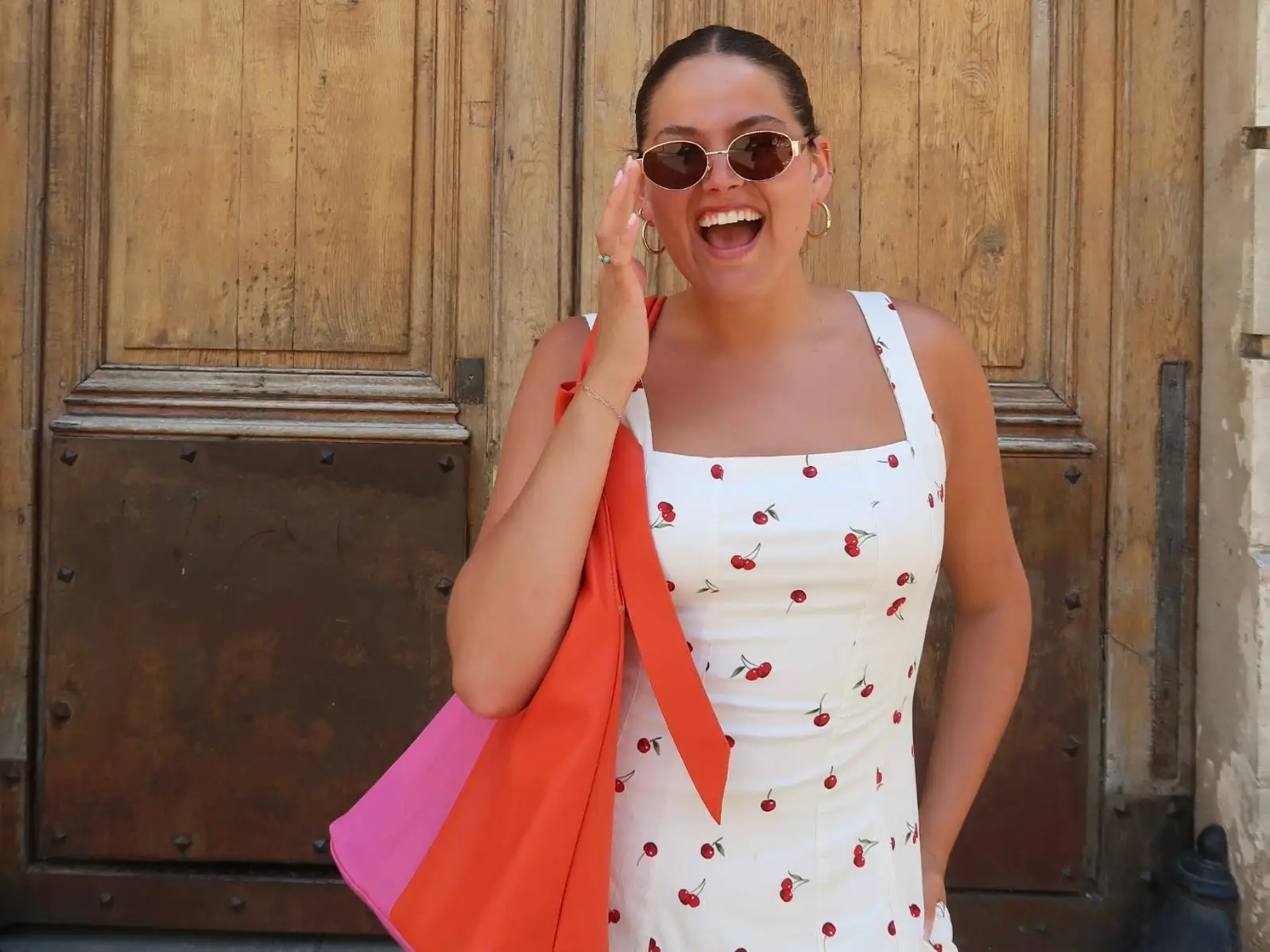 Woman smiling in France with sunglasses on
