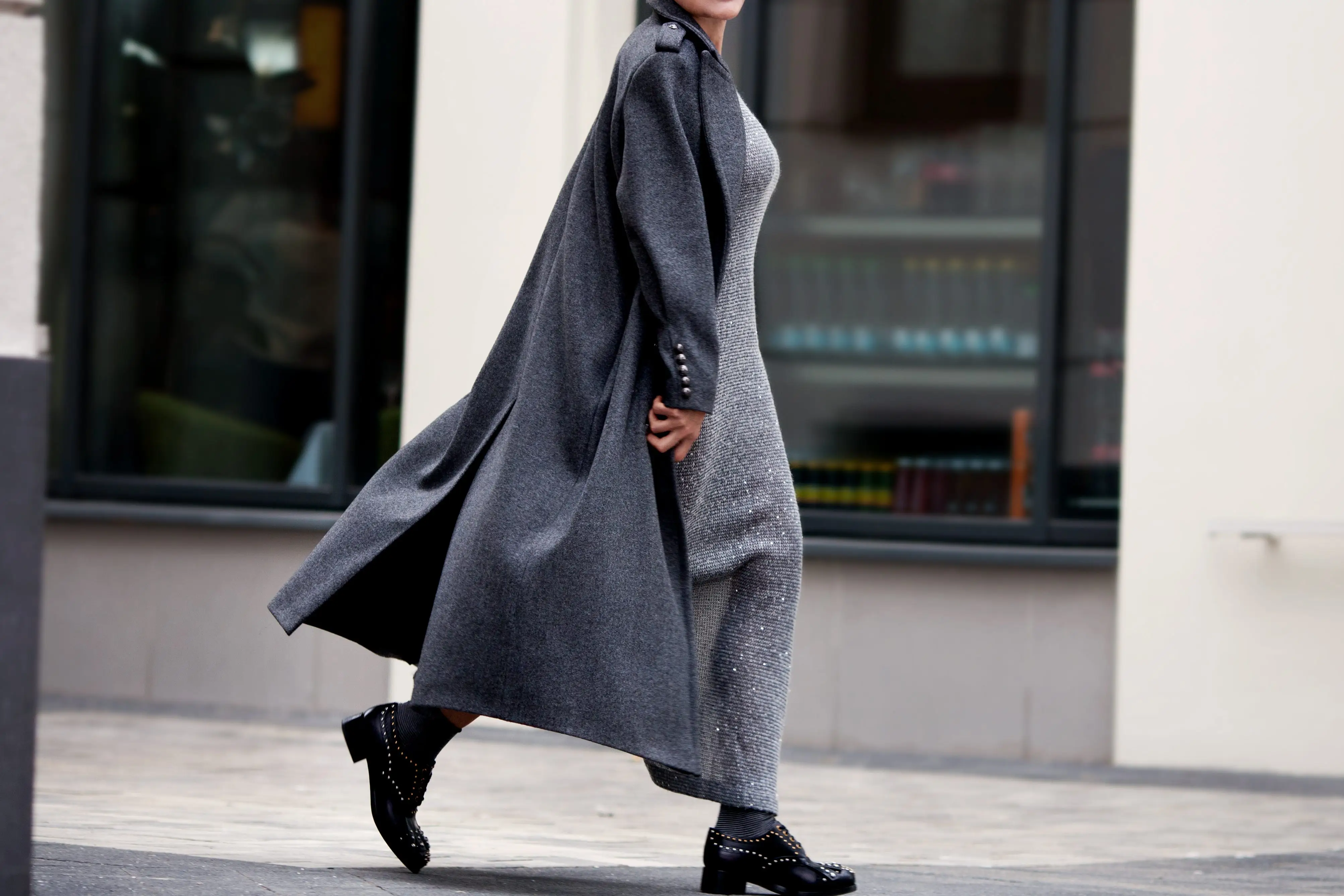 woman walking on city street in neutral clothing