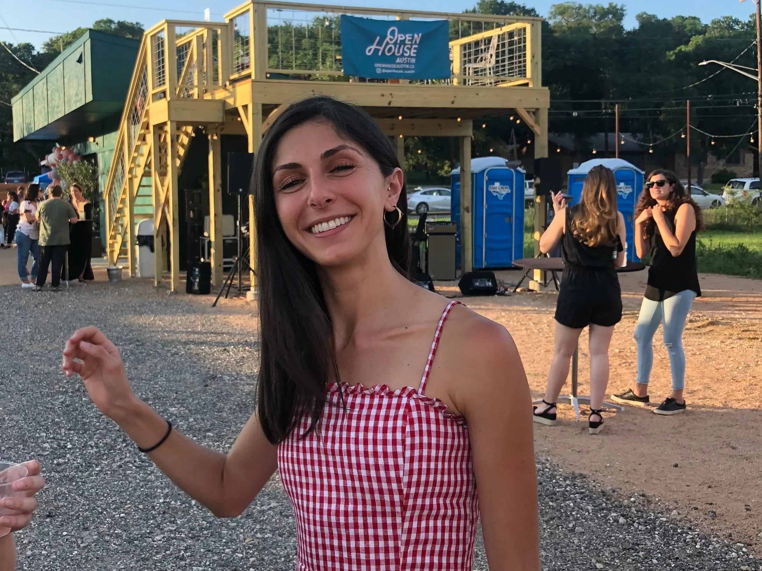 A woman stands in front of a tall staircase with a sign that reads 