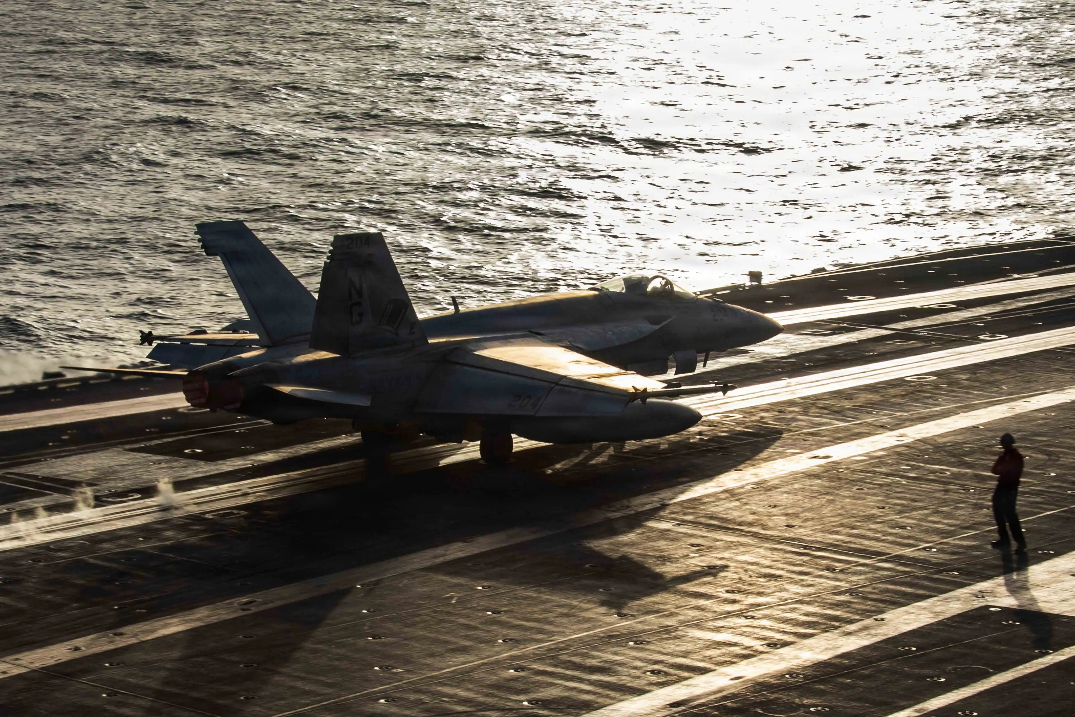 An F/A-18E Super Hornet launches from the flight deck of the USS Abraham Lincoln aircraft carrier.