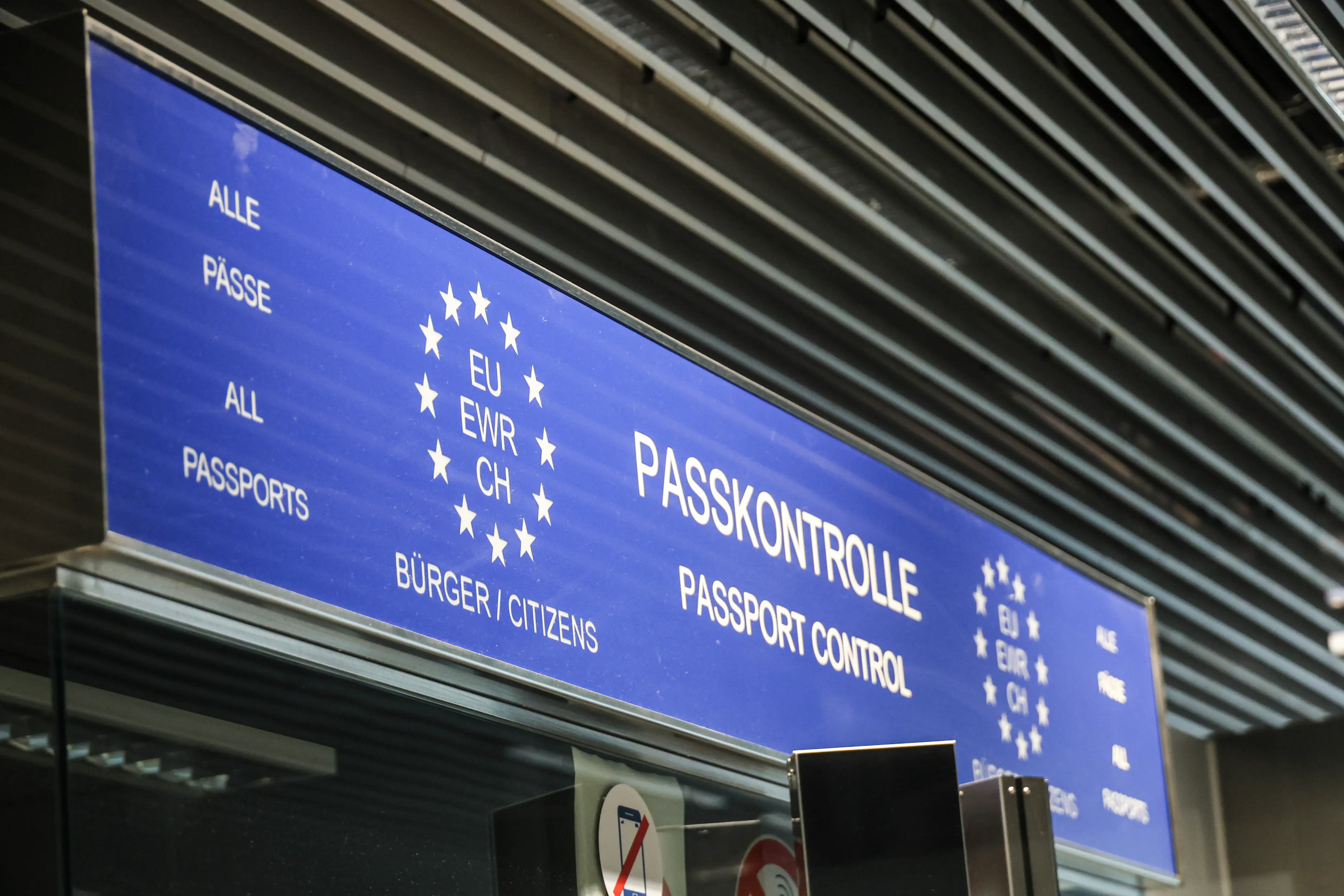Border Control and passport control signs and post in the terminal building after the gates at Dusseldorf International Airport