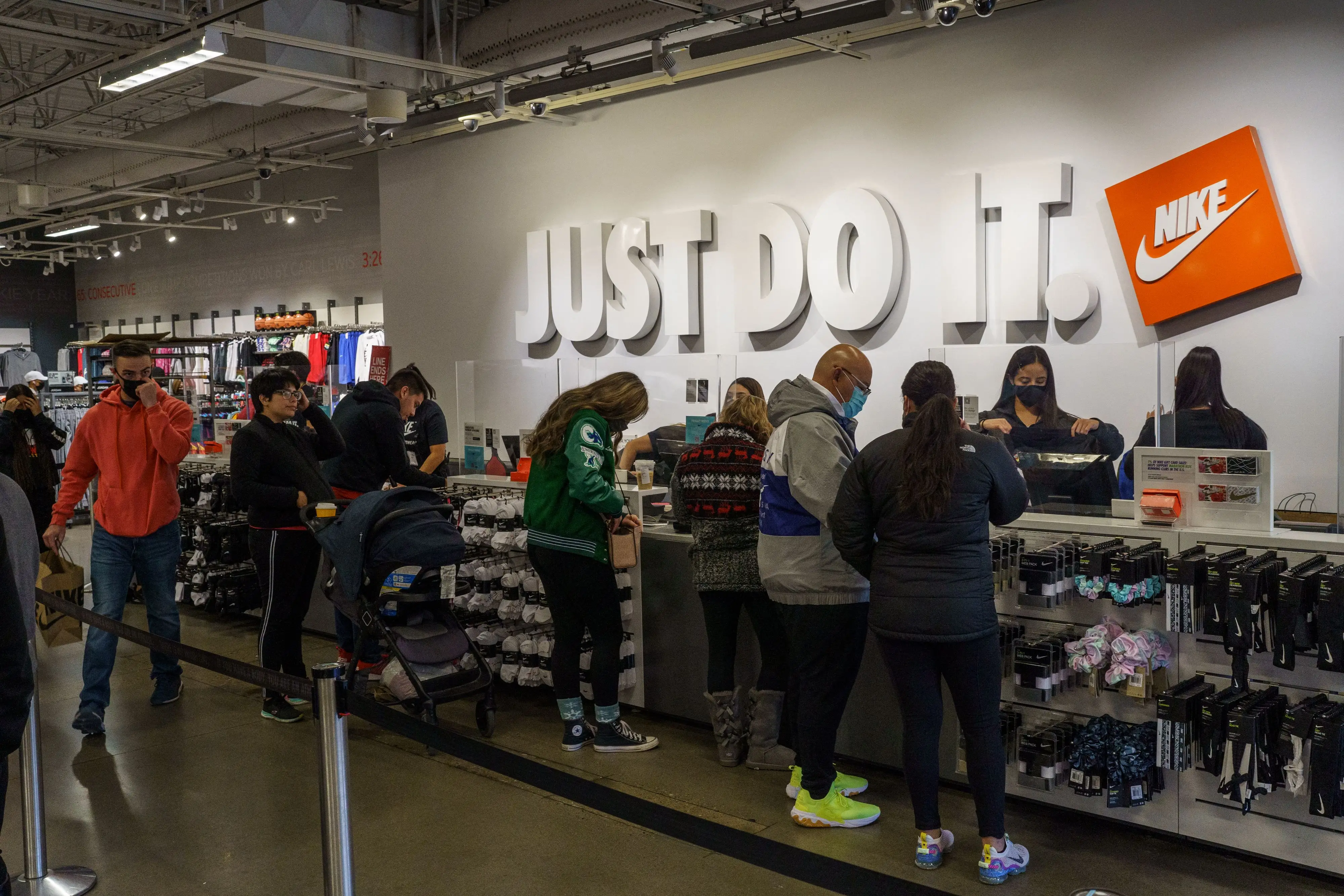 Shoppers are pictured in the Nike Factory Store at the Outlet Shoppes at El Paso on Black Friday in El Paso, Texas on November 26, 2021.