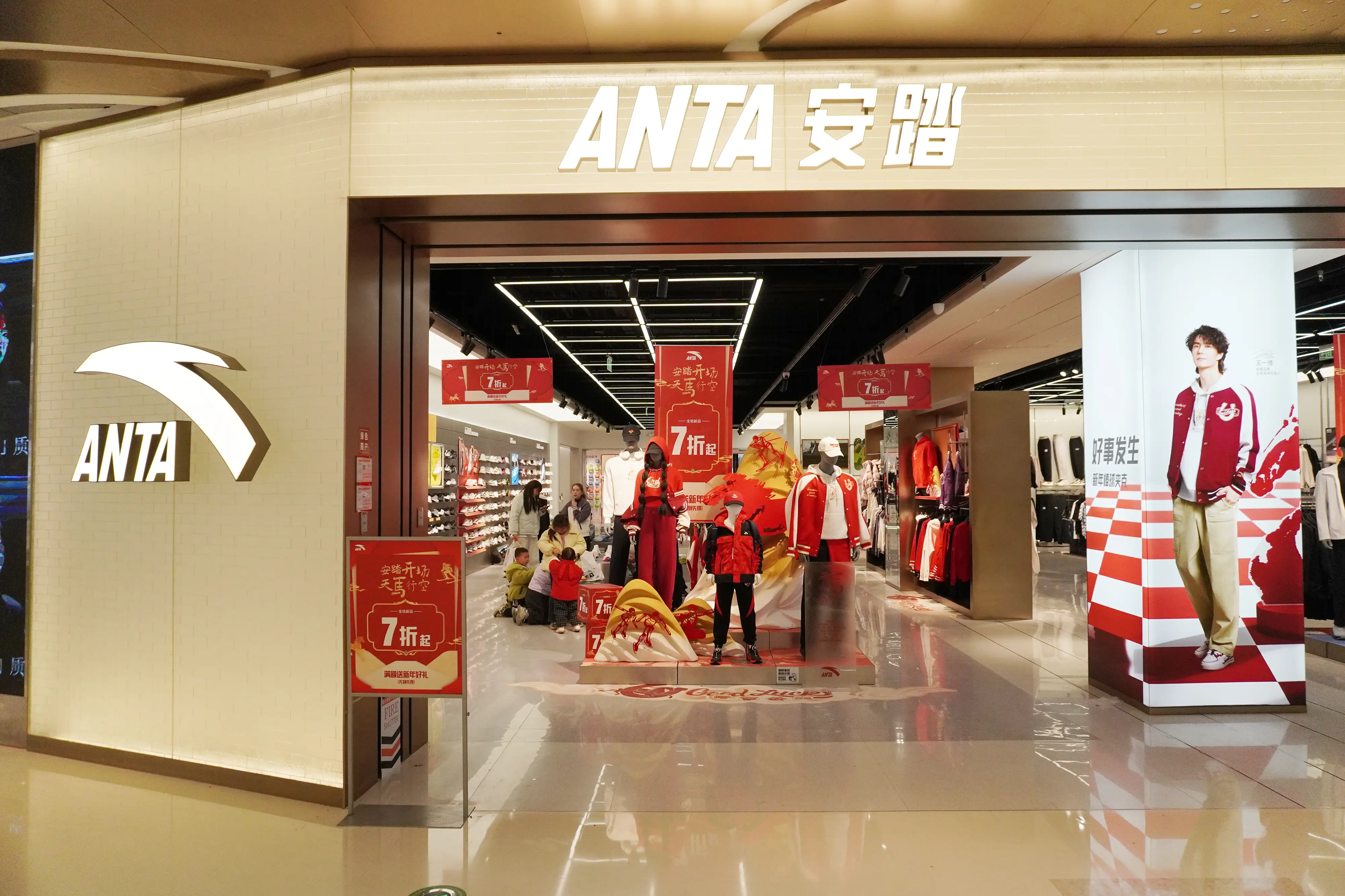 The ANTA store features a vibrant red and gold festive display, with a 