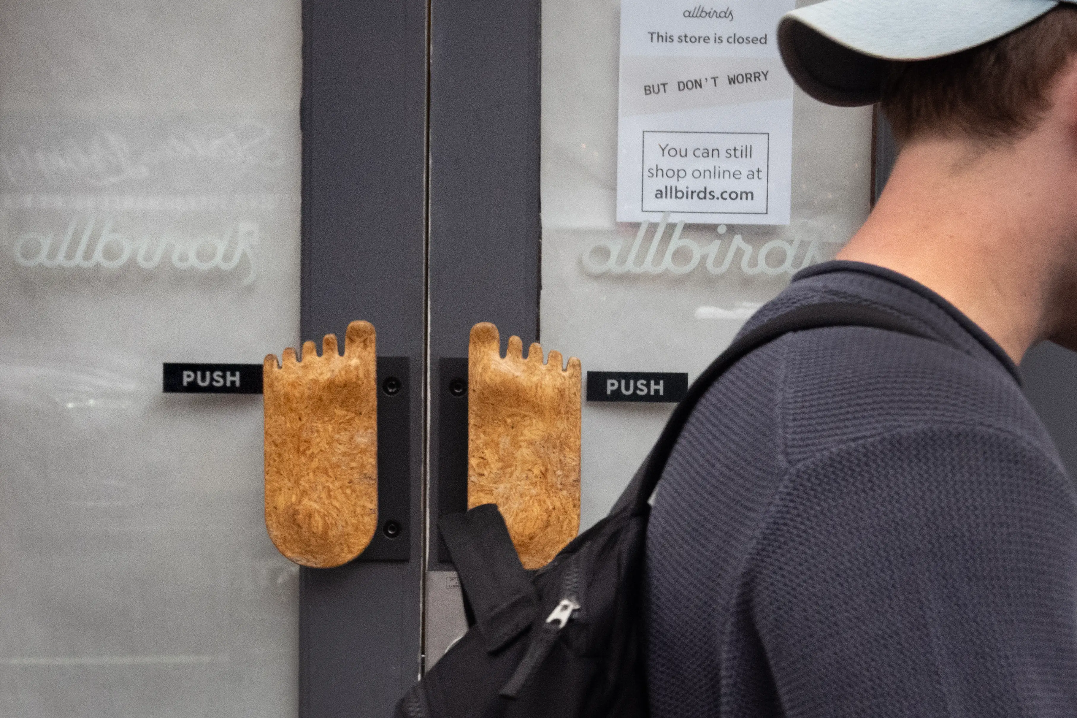 A sign at the entrance of an Allbirds store says 