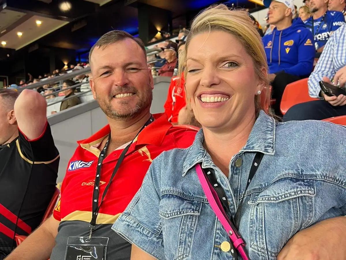 A man and woman at a sports game.