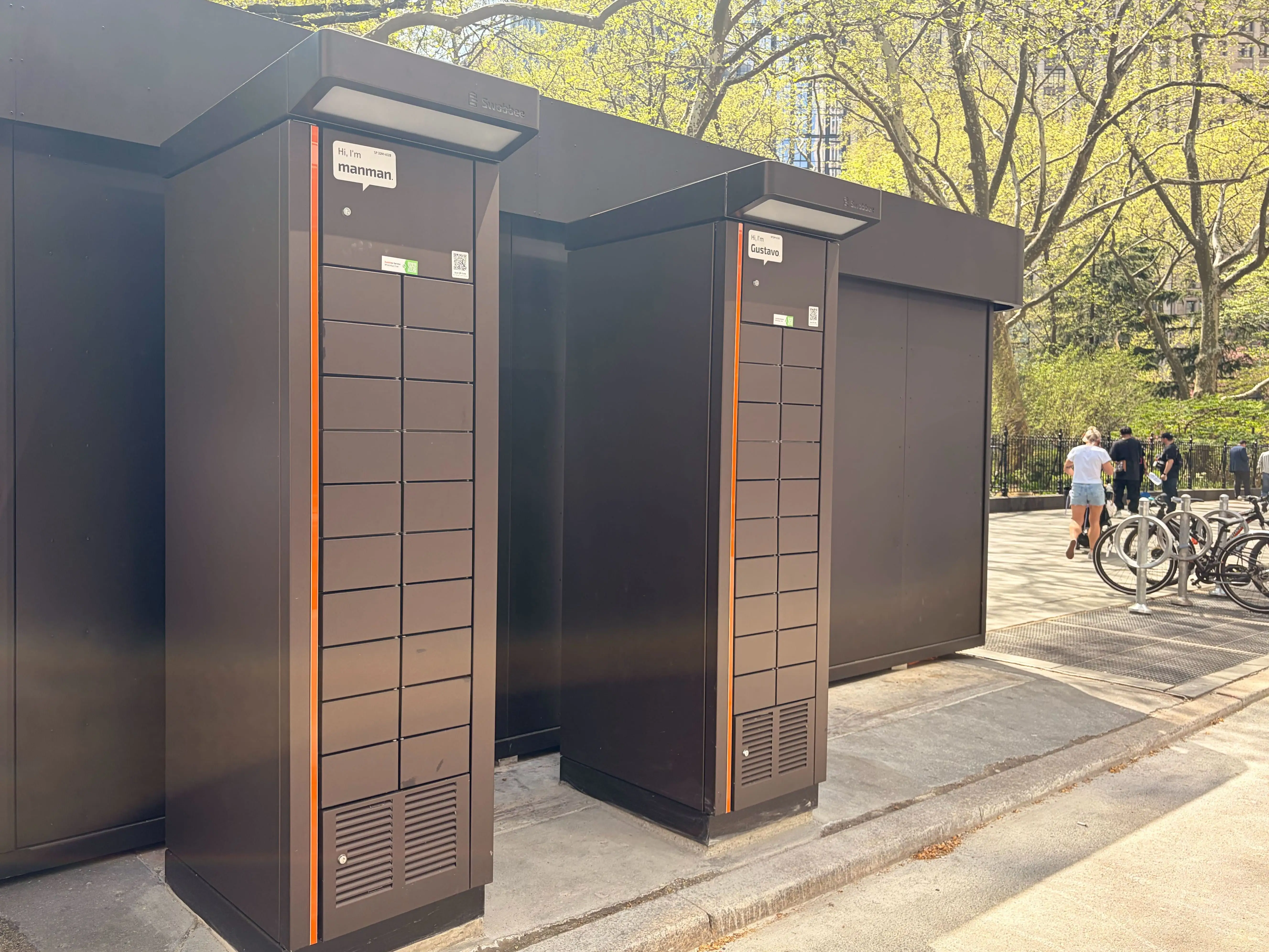 Two large bike battery charging towers, with 20 cabinets each, rest behind the Deliverista hub.