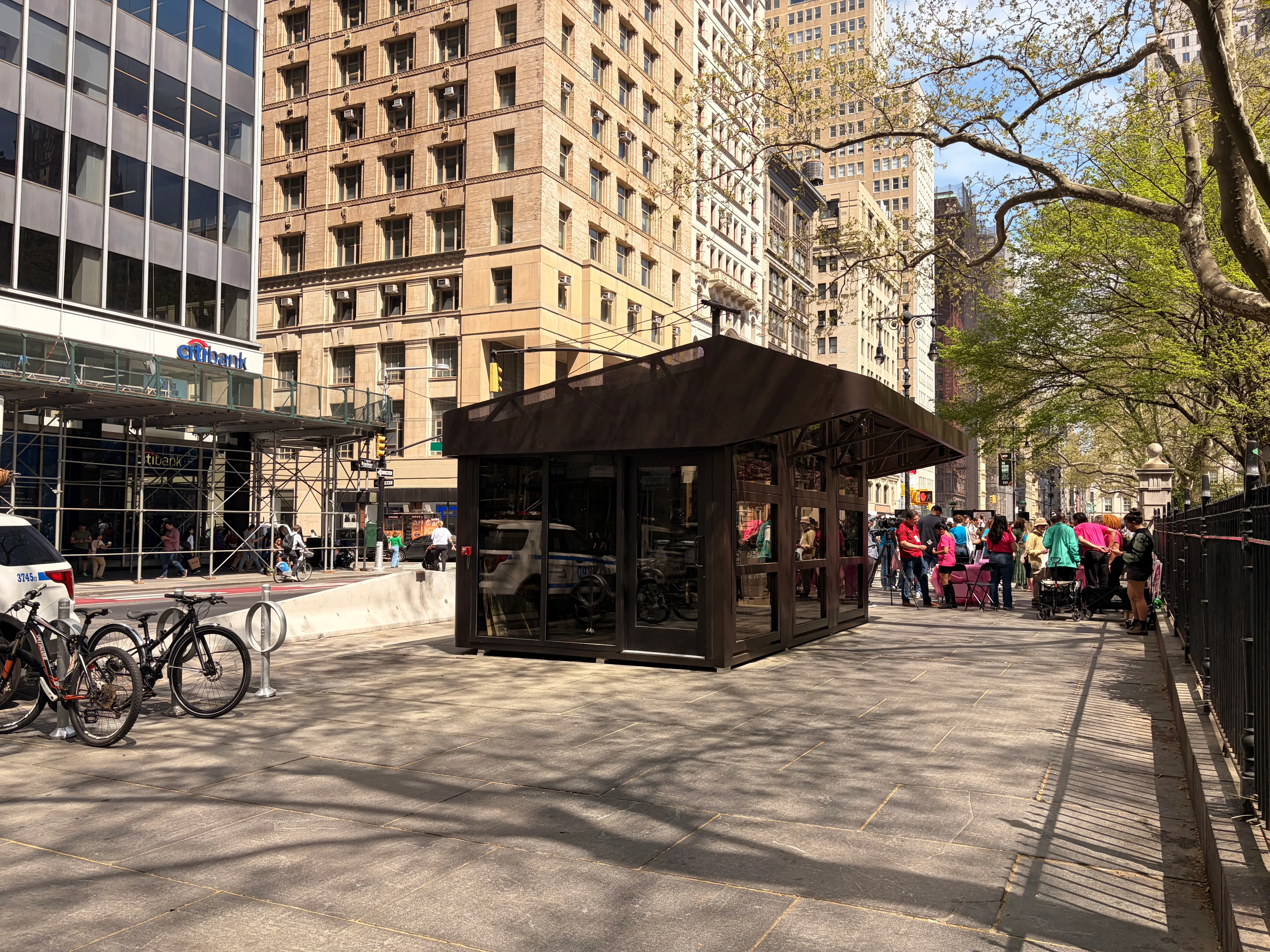 The empty Deliverista Hub rests underneath several trees inside City Hall's campus.