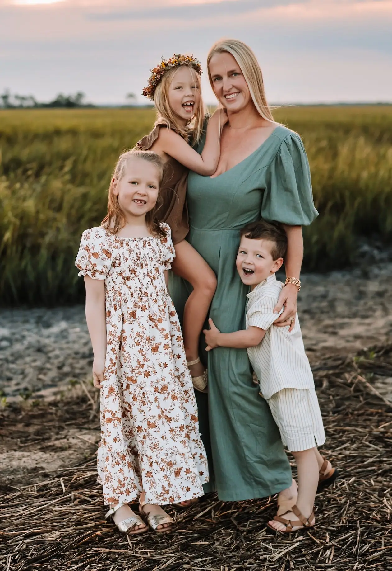 Alex Otto hugs her three children on a shoreline.