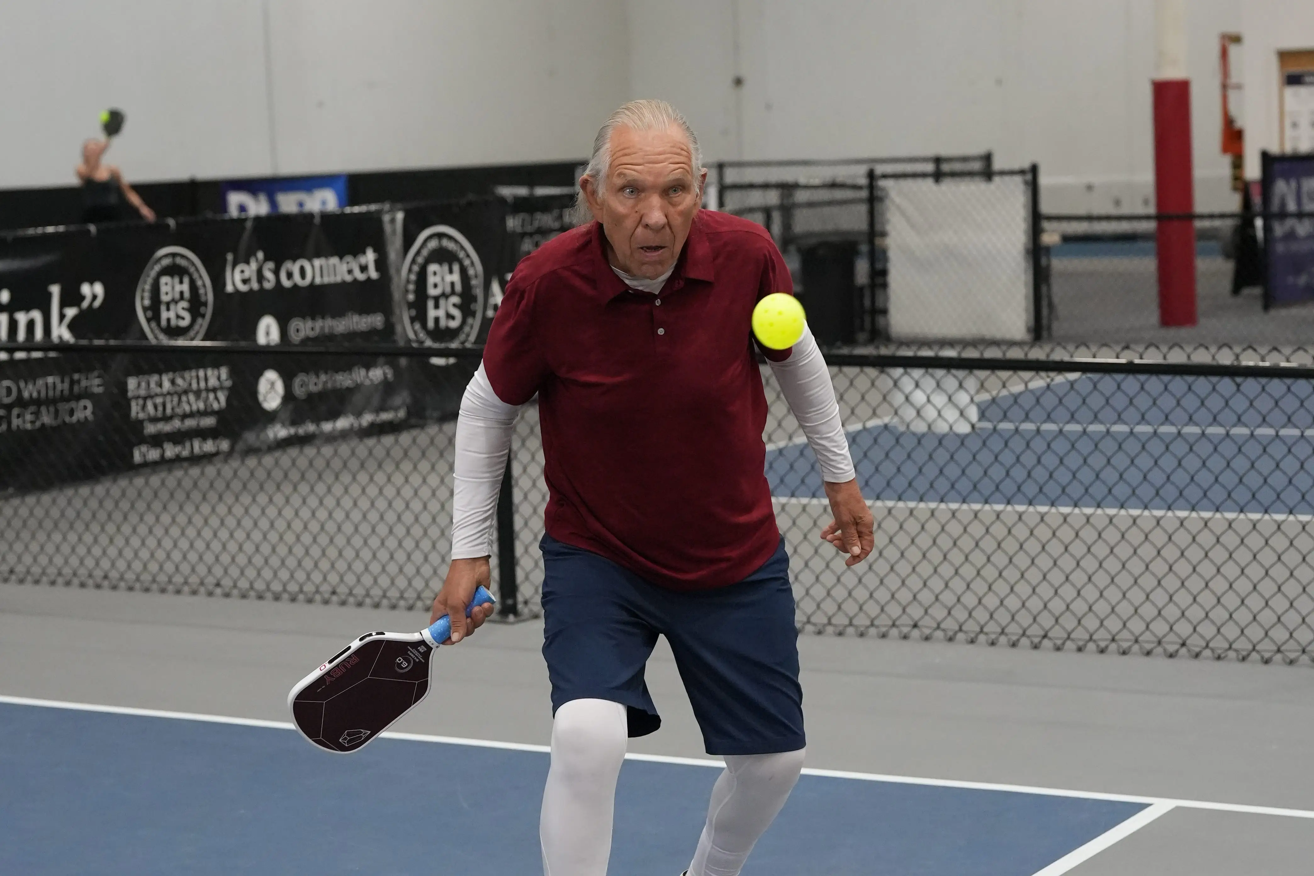 A man playing pickleball.