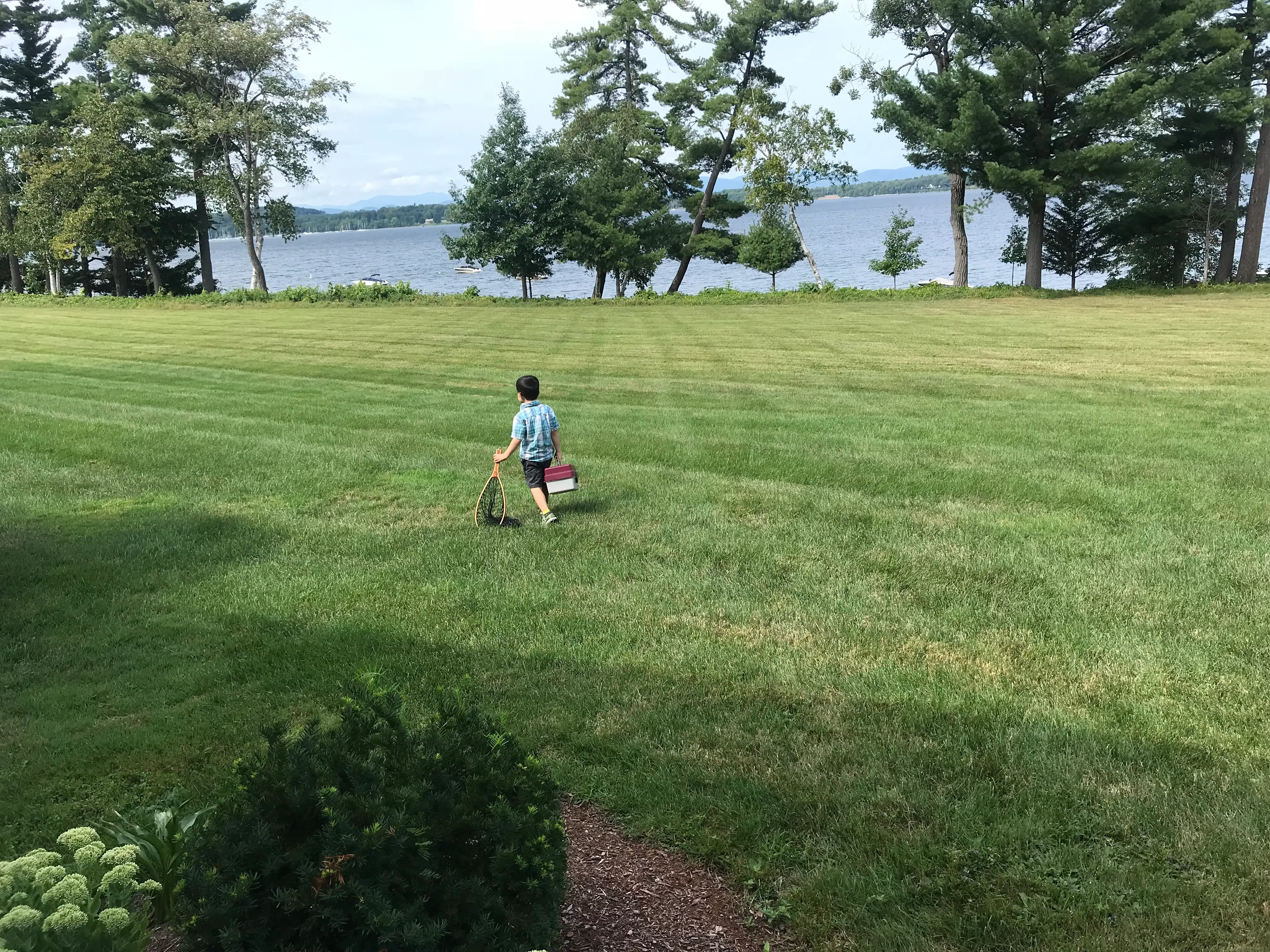 The author's son walks down to a lake to go fishing.