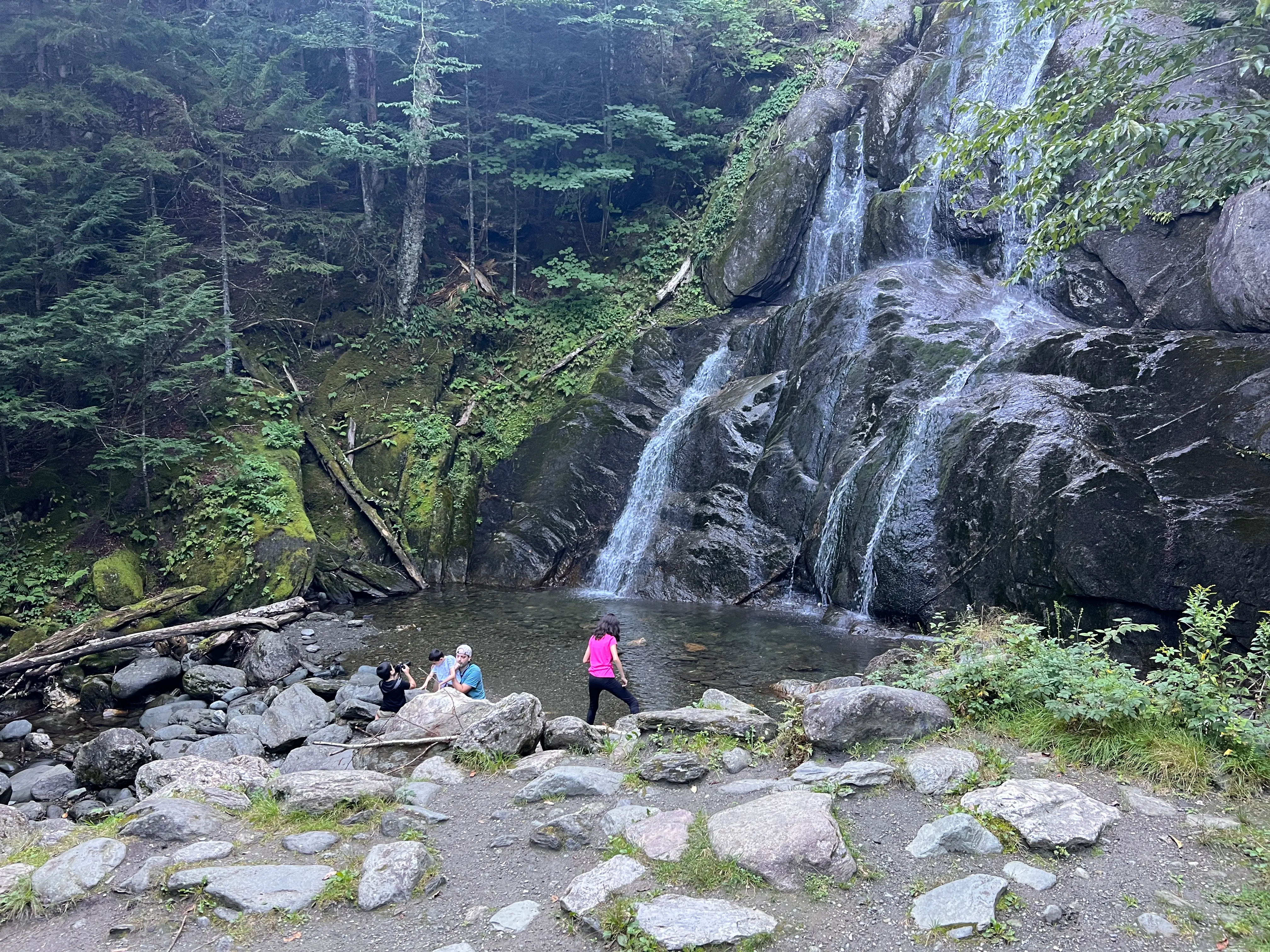 The author's family explores a waterfall while on vacation in Vermont.