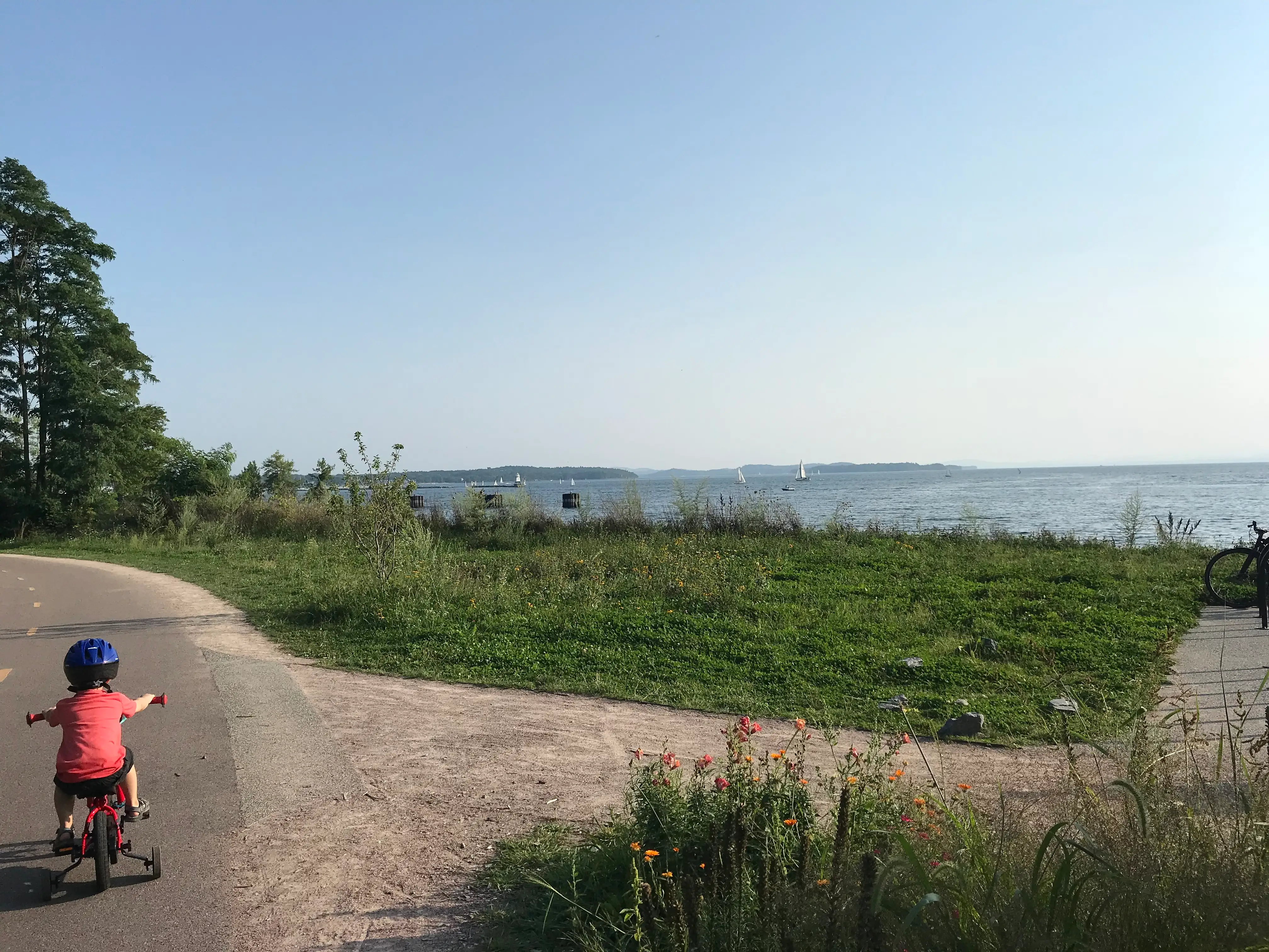 The author's child rides a bike with training wheels in Vermont.