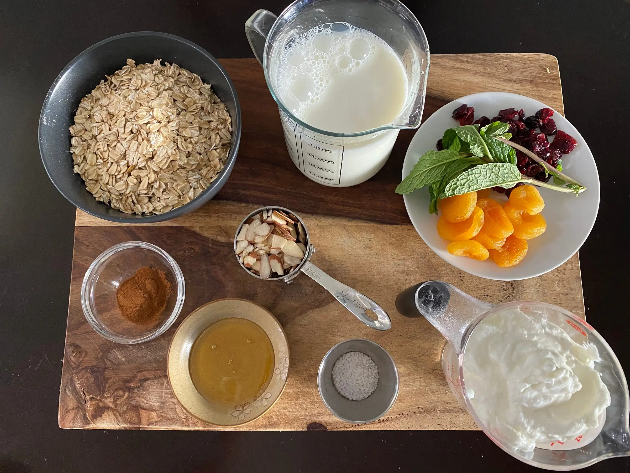oats, milk, dried fruit ingredients on cutting board