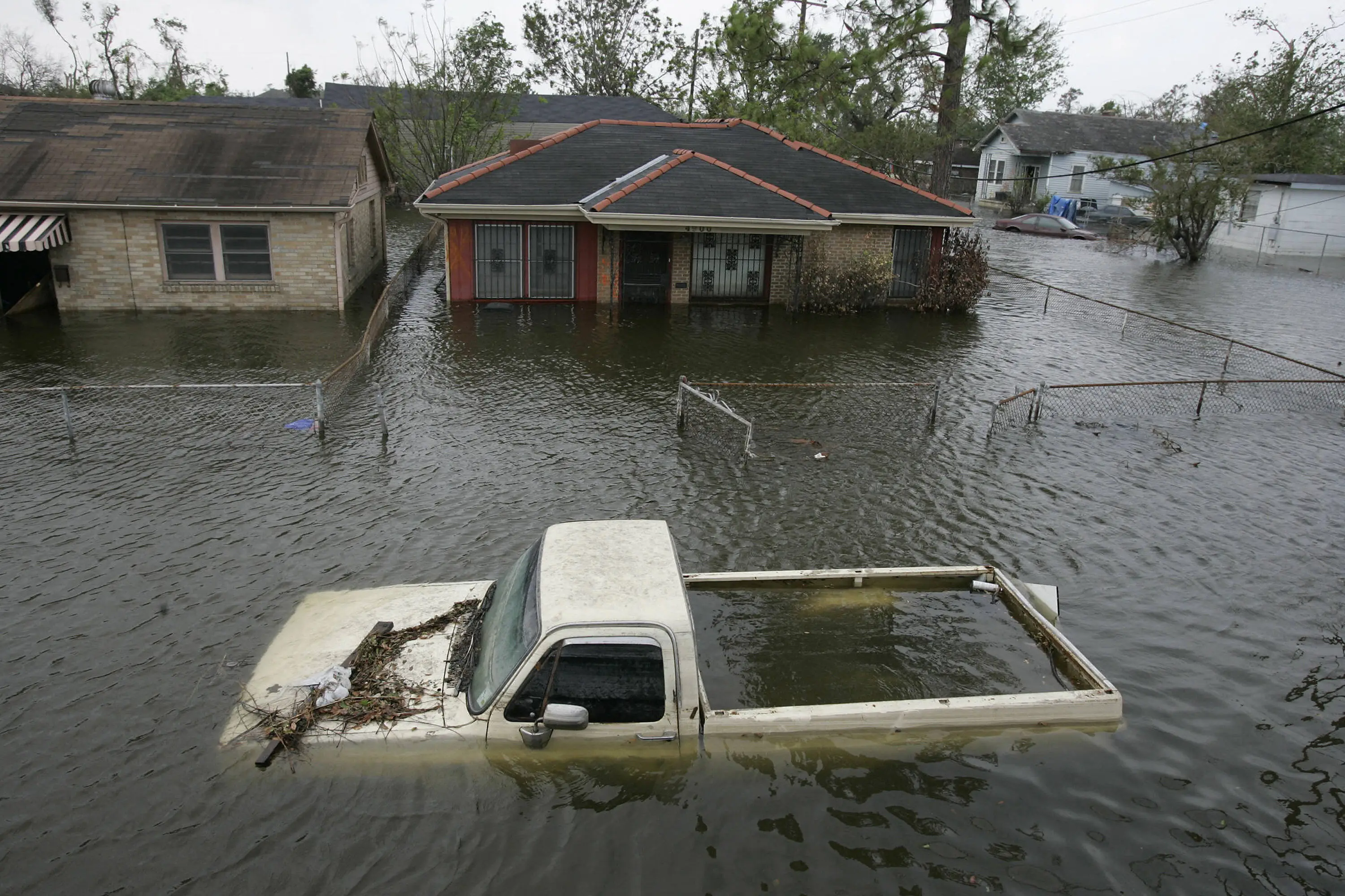 A pickup truck is filled with water on a street in the Ninth Ward of New Orleans, 24 September 2005, after a storm surge from Hurricane Rita breeched a patch in the levee of the Industrial Canal, reflooding the area.