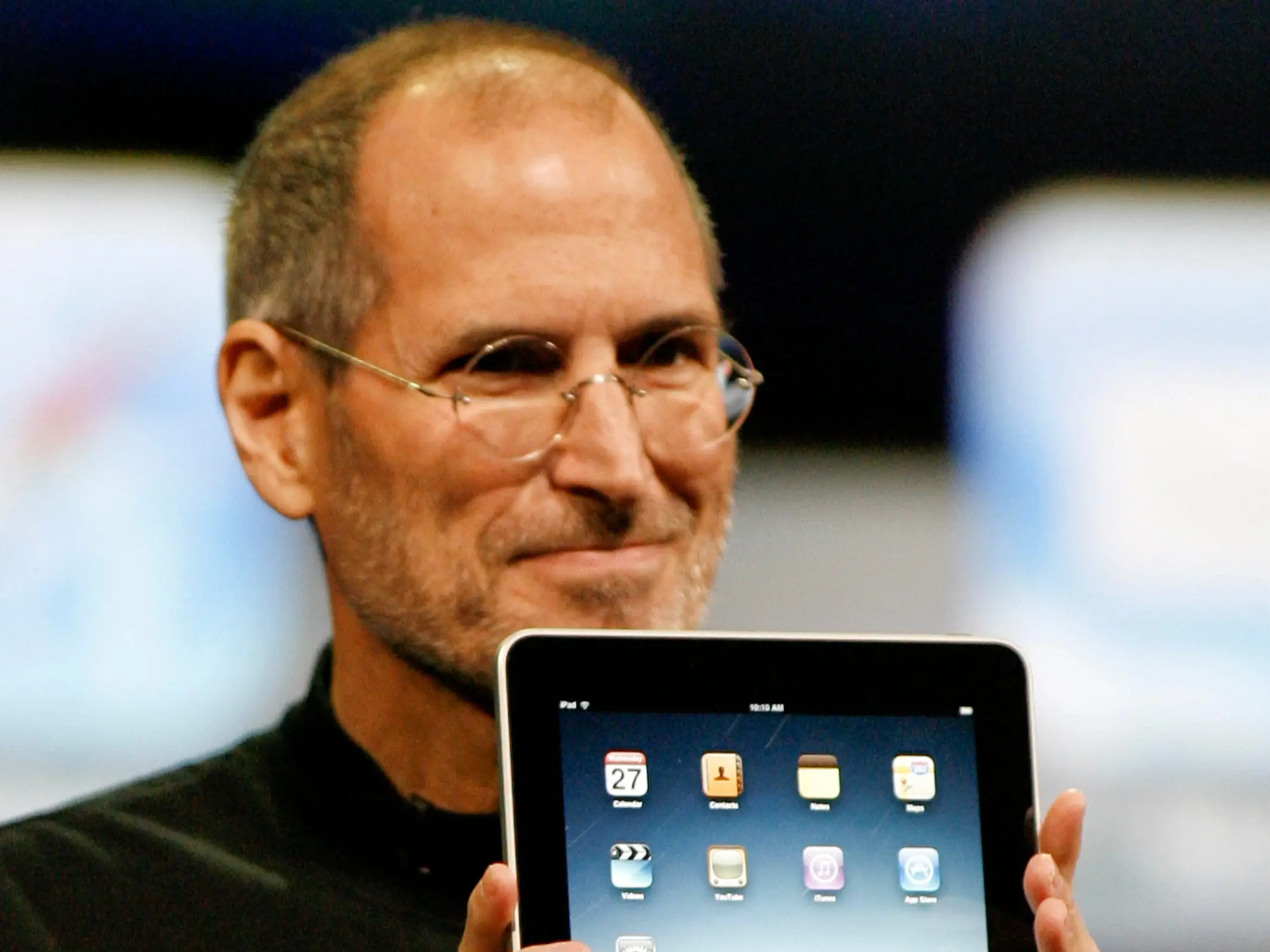 Steve Jobs holding an ipad