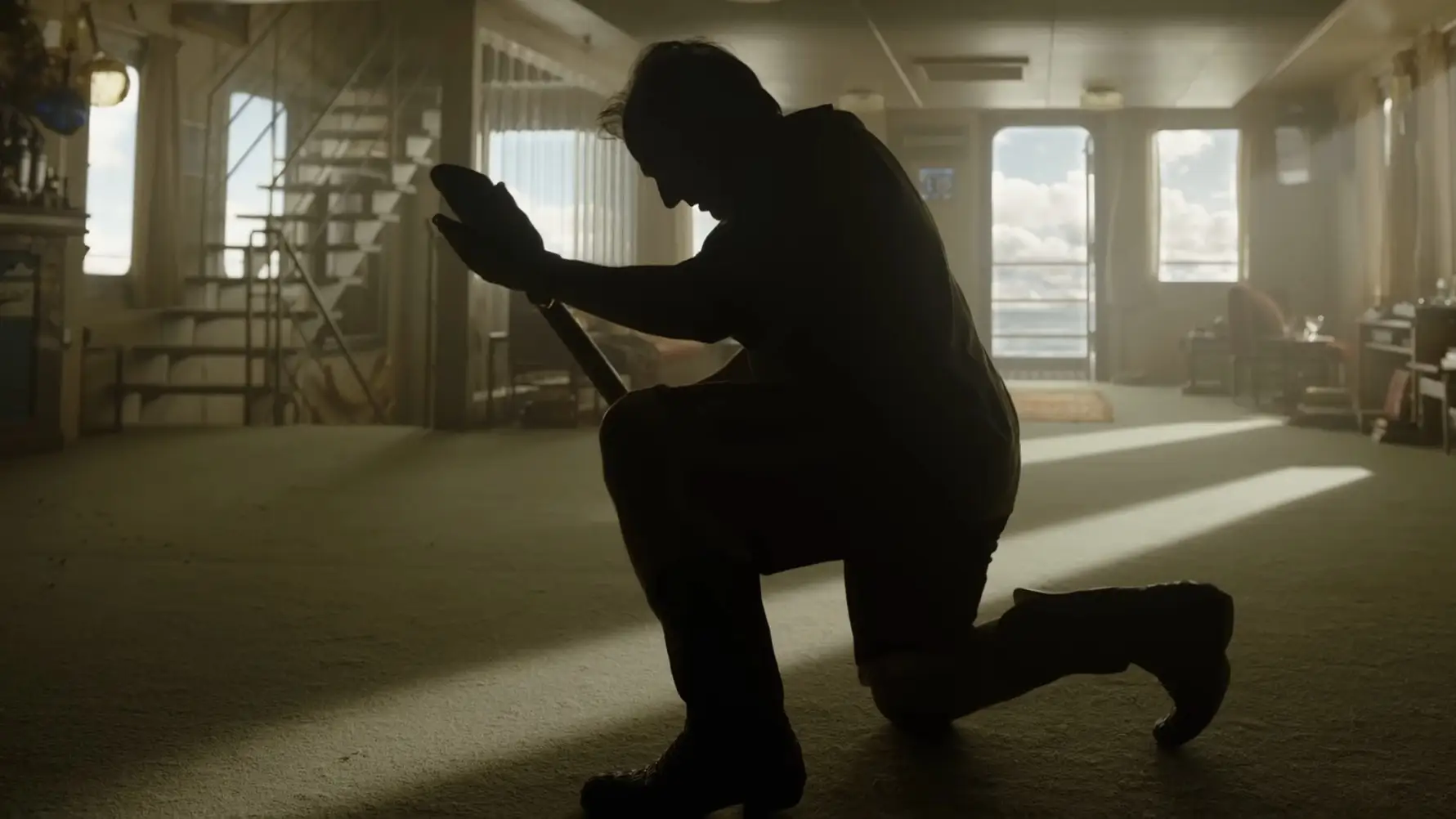 Tom Cruise kneeling with a shovel in Digger movie