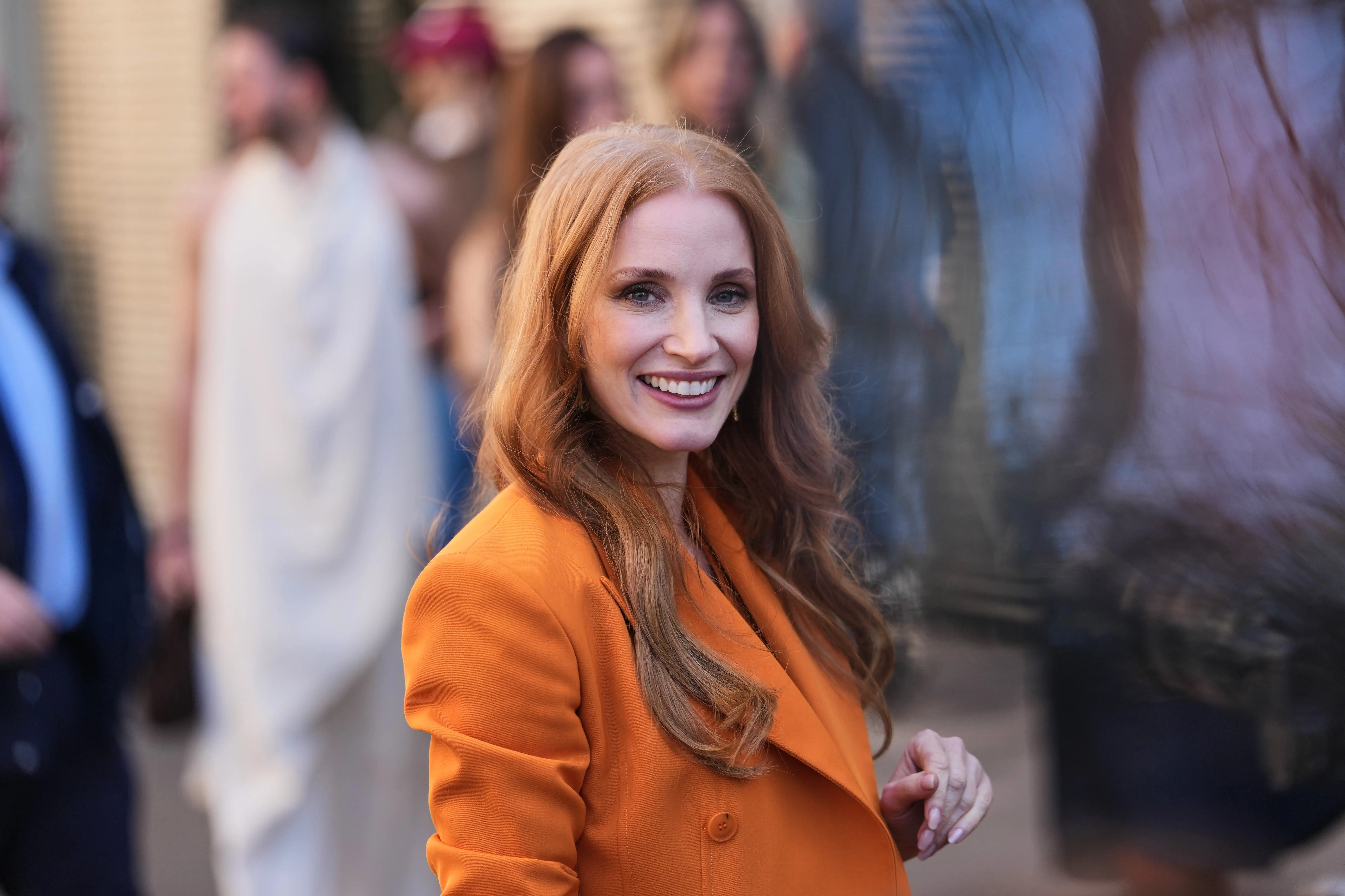 Jessica Chastain in an orange jacket