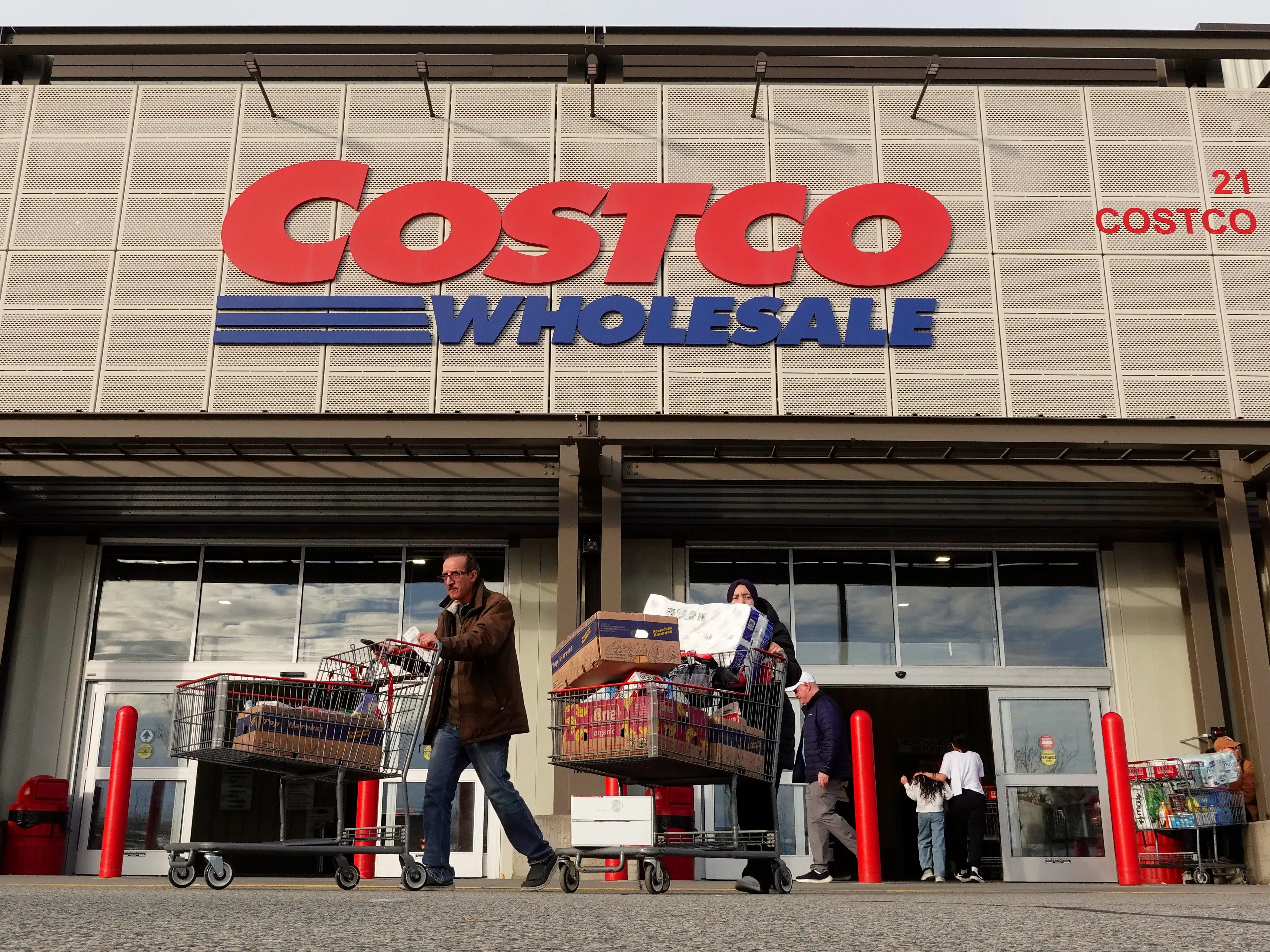 People leave a Costco Wholesale store after shopping on March 21, 2026, in Bayonne, New Jersey.
