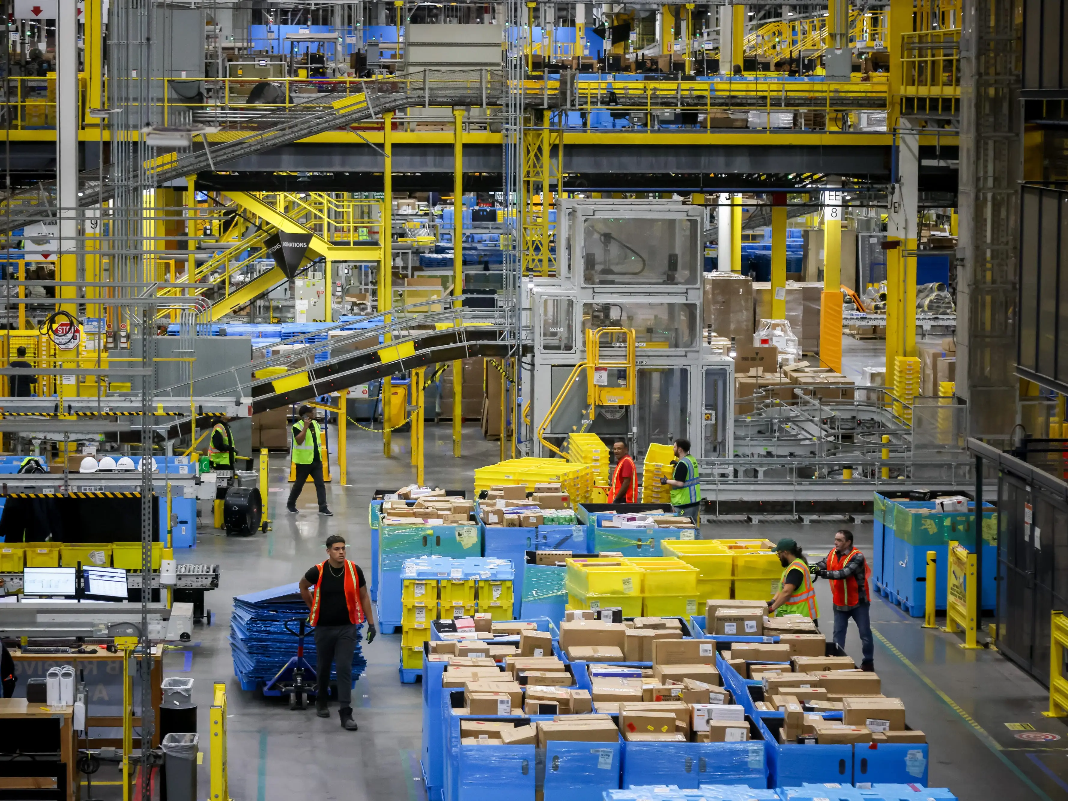 Workers at an Amazon fulfillment center on Cyber Monday in Robbinsville, New Jersey, US, on Monday, Dec. 1, 2025.