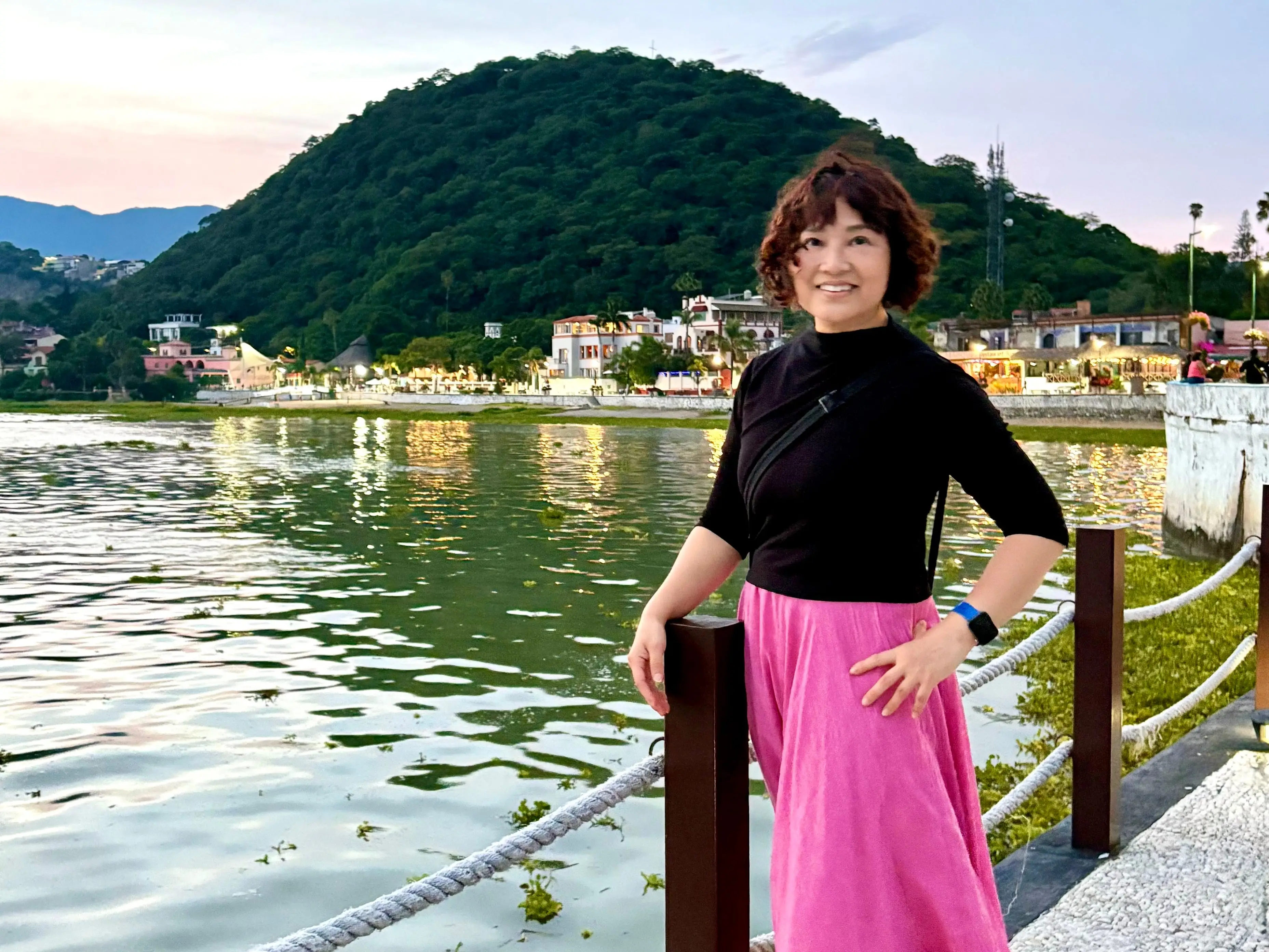 Author IVy Ge smiling in Mexico next to water