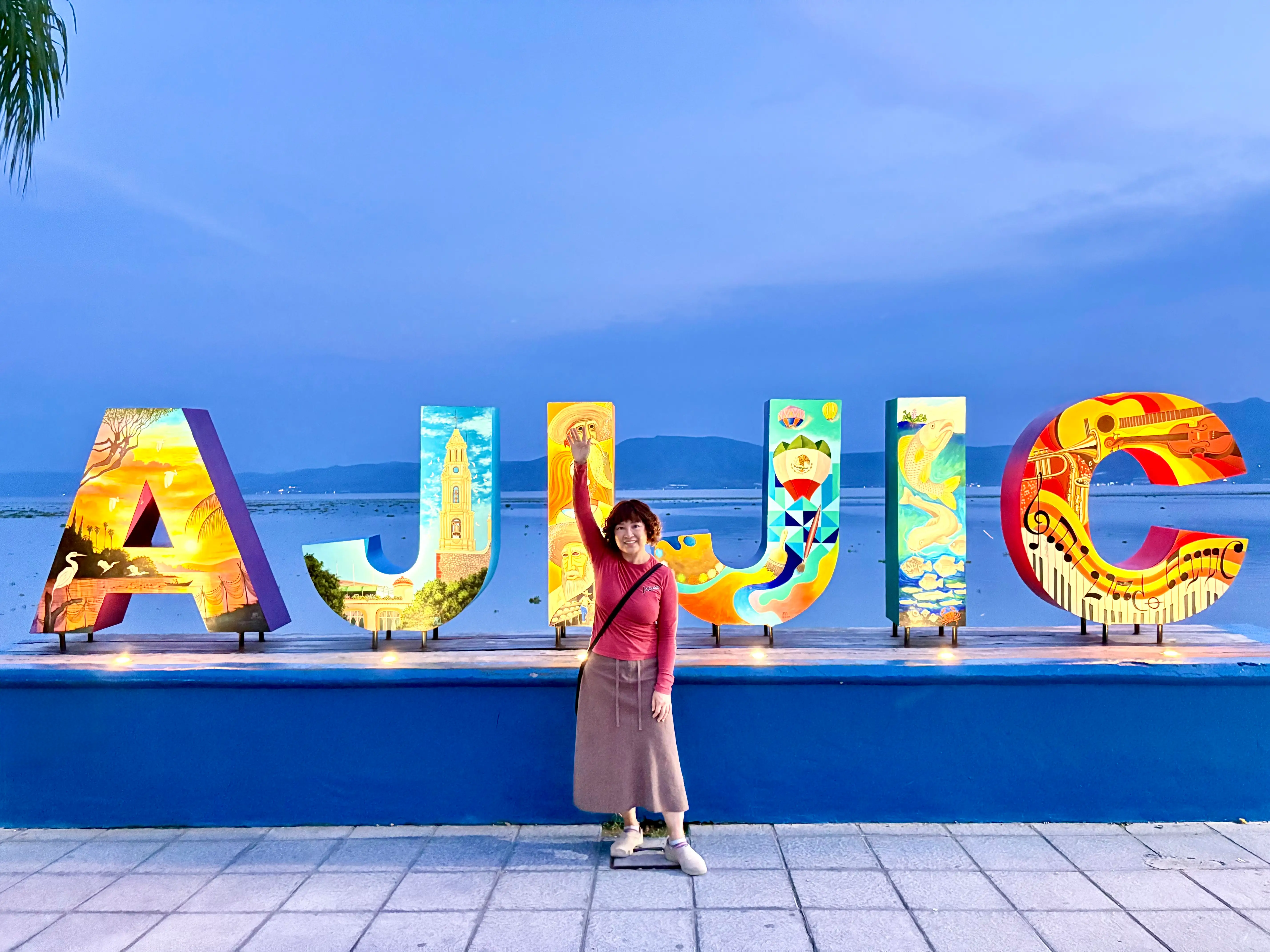Woman posing in front of Ajijic sign