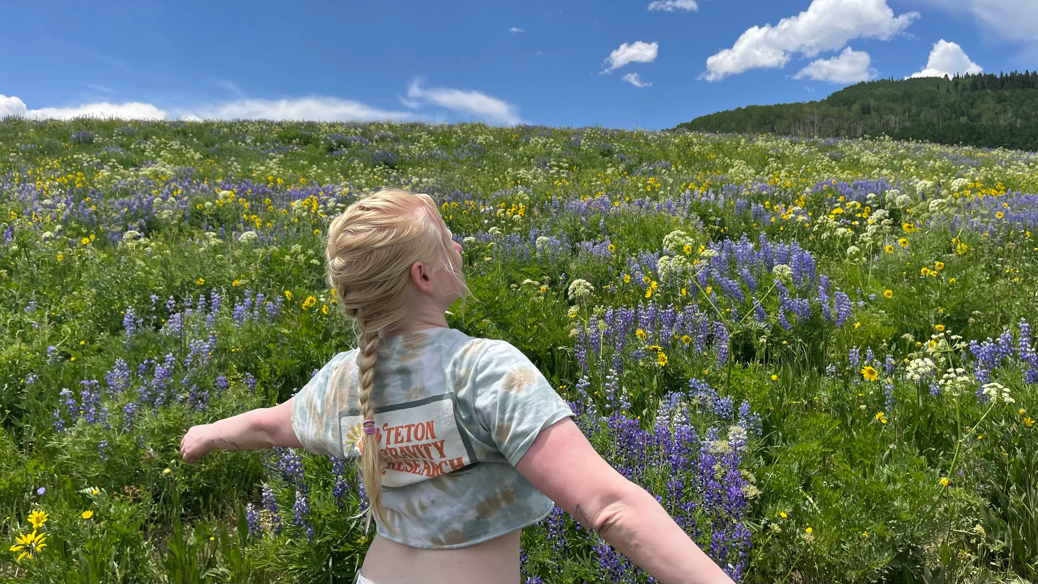Woman smiling in field of wildflowers