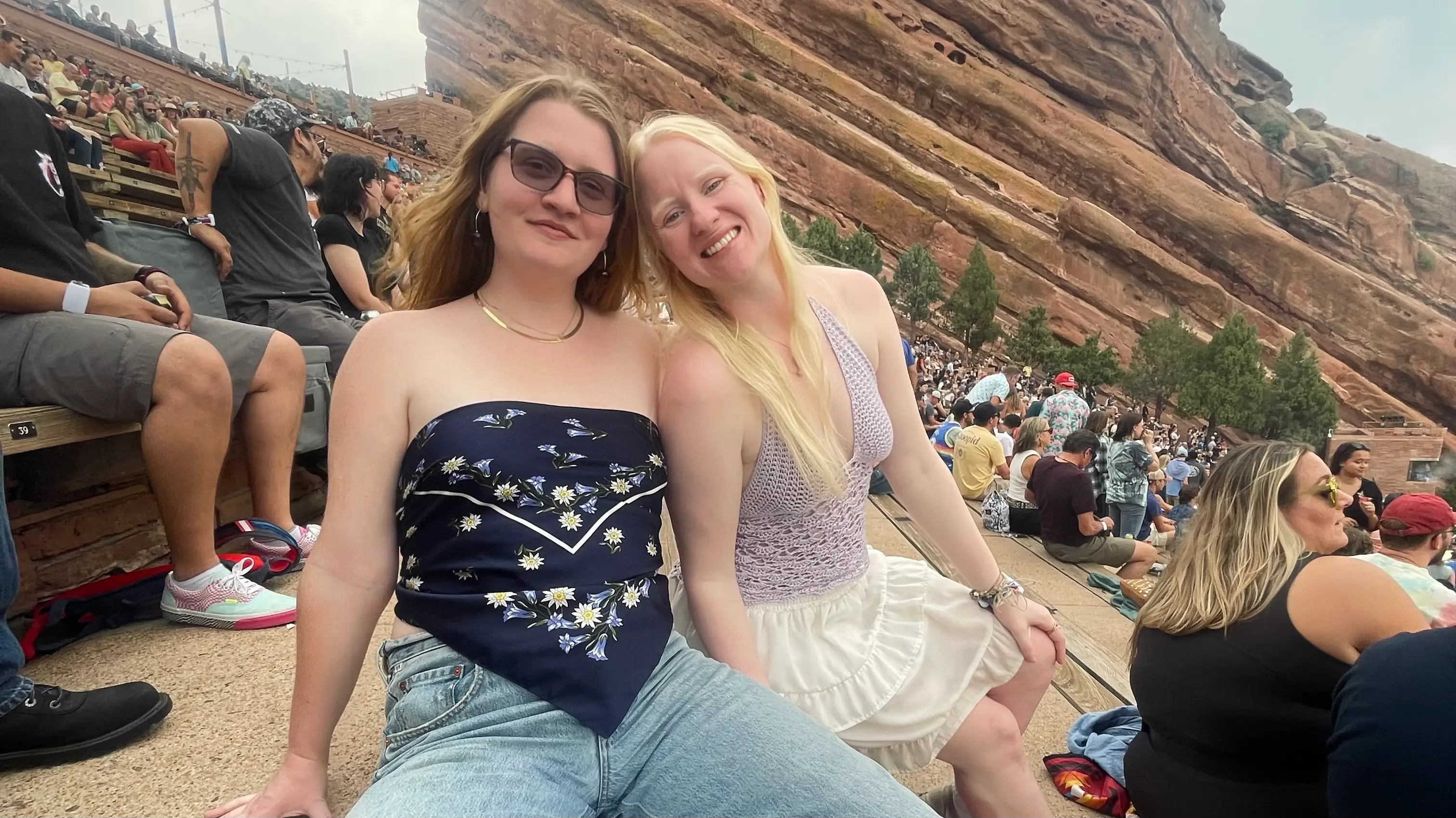 woman smiling with friends in redrock amphitheater