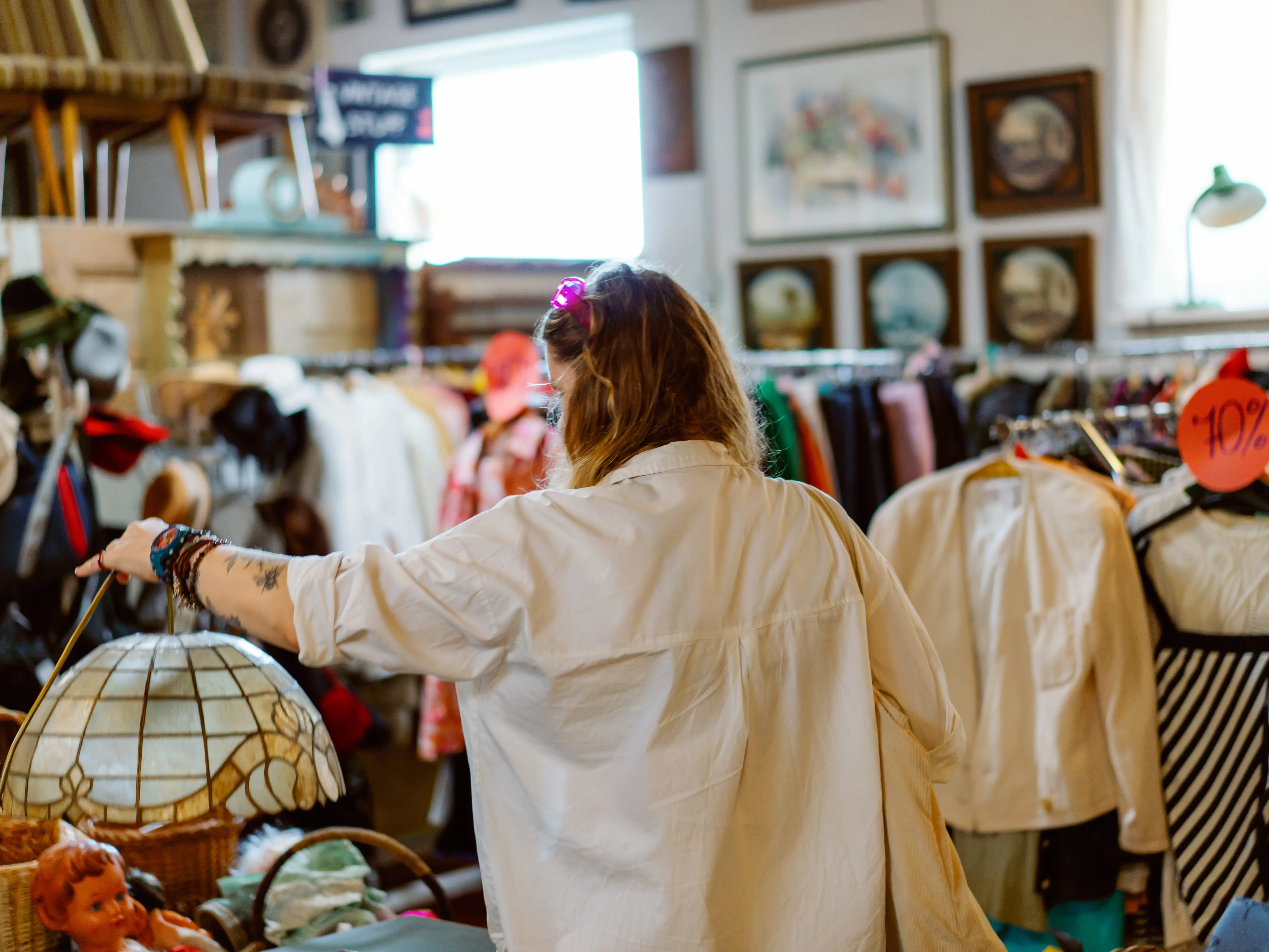 A woman shopping in a thrift store.