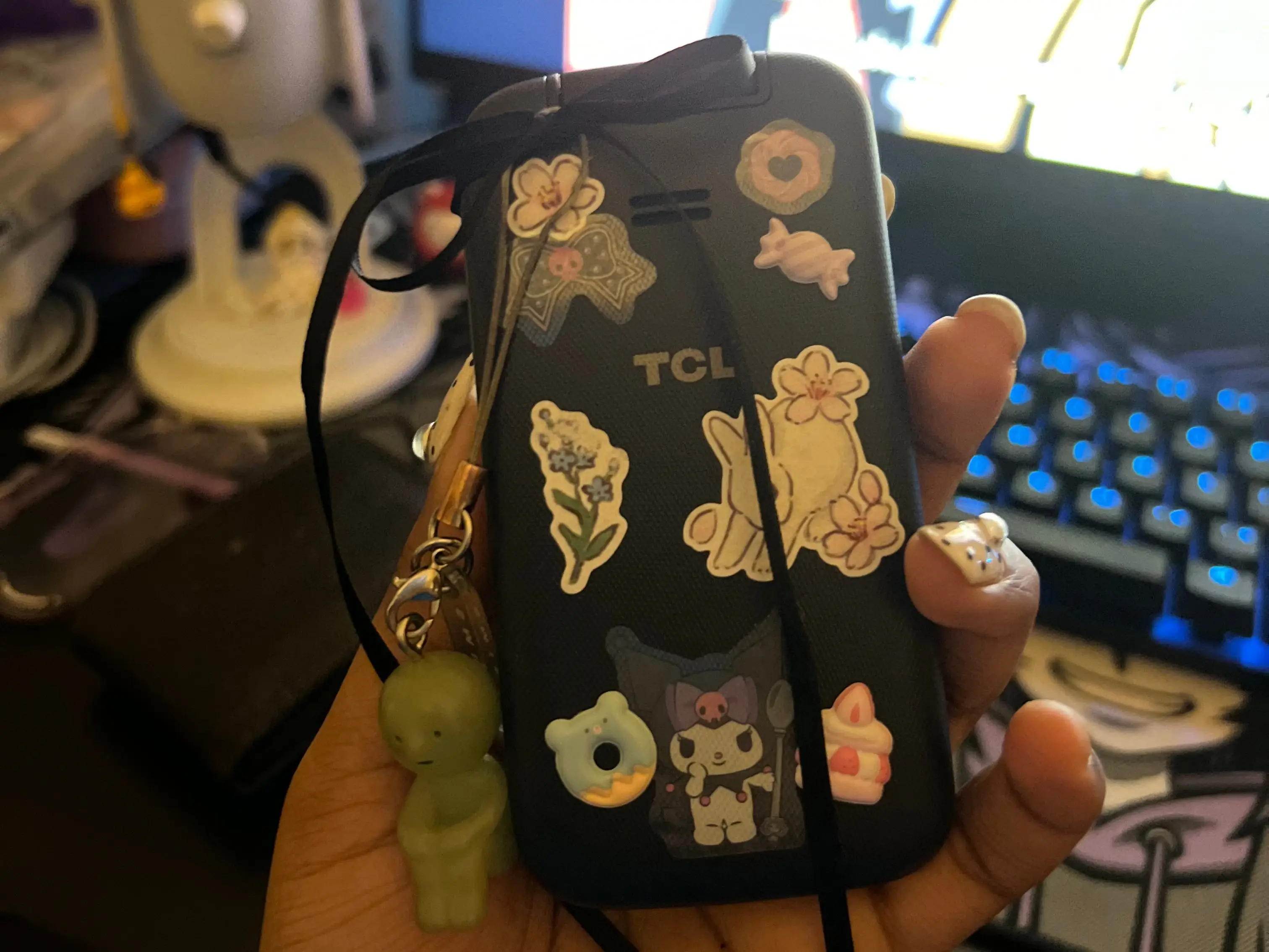 A TCL flip phone with stickers