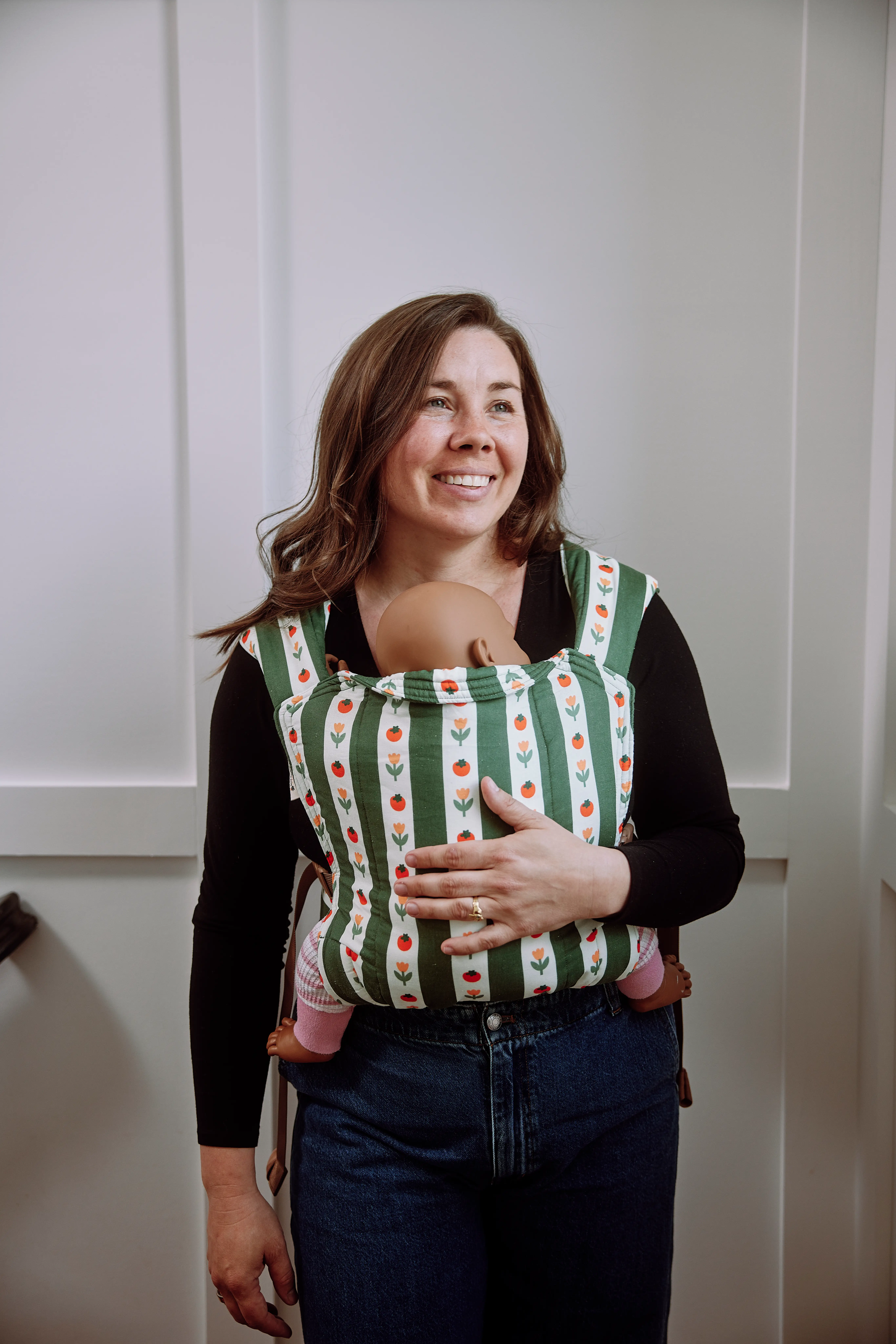 Skye, Hope&Plum's CEO and cofounder, posing with a buckle carrier in her home.