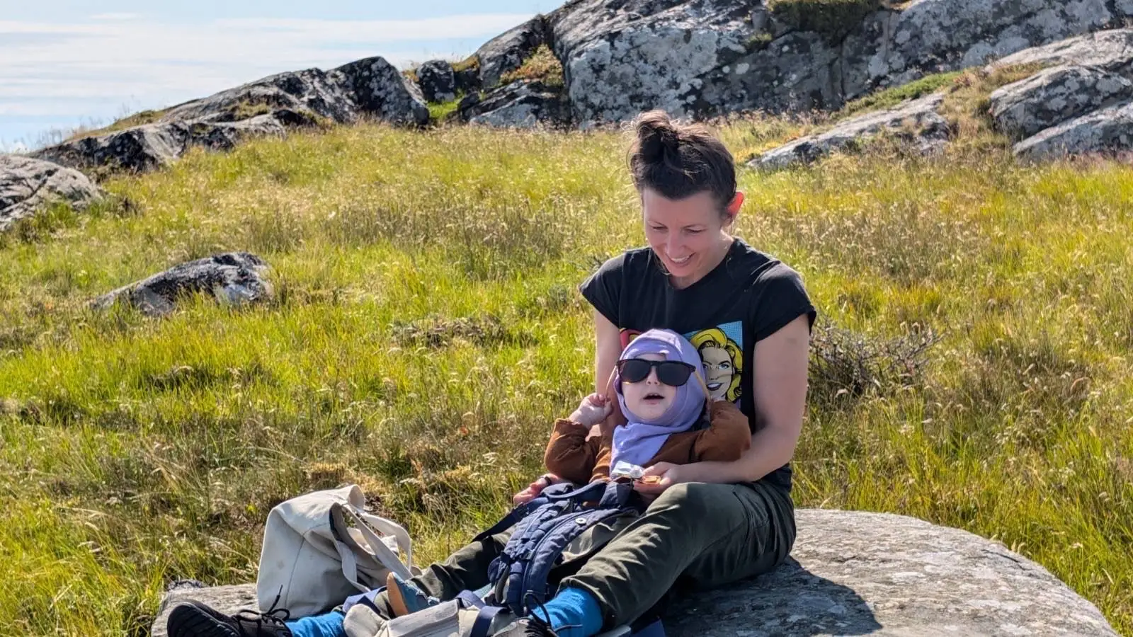 Woman with baby in sunglasses in her lap