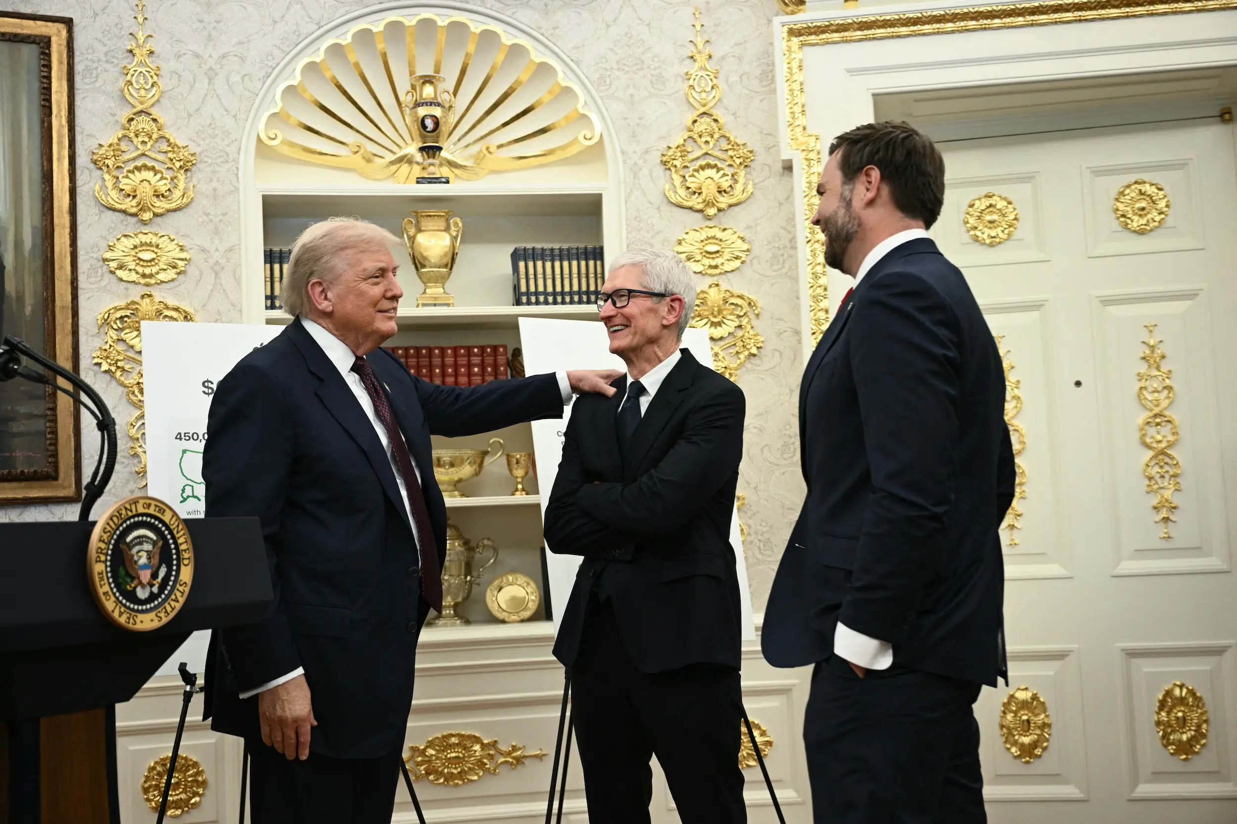 Donald Trump, Tim Cook, and JD Vance talk in the Oval Office