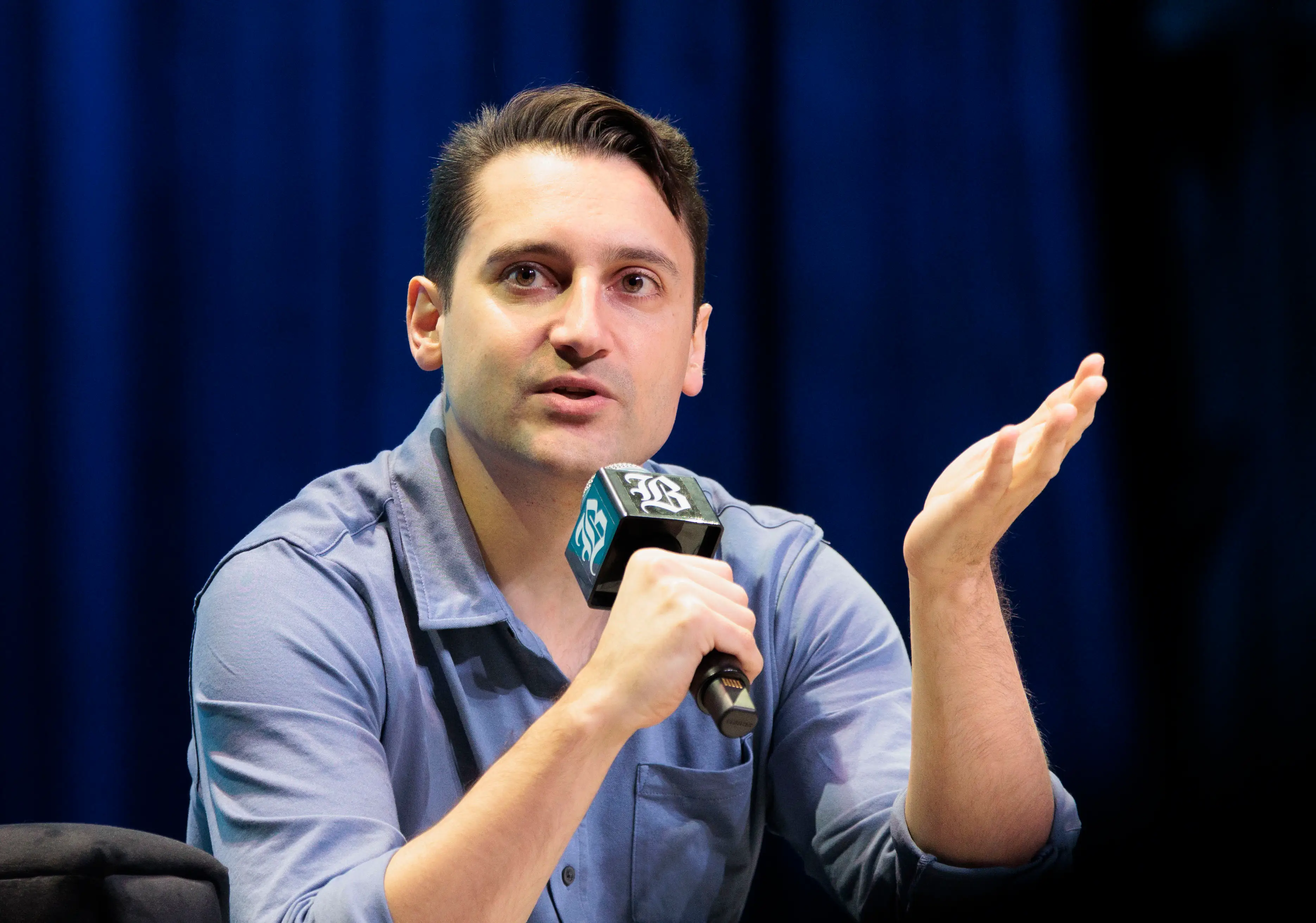 Ben Collins holding a mike