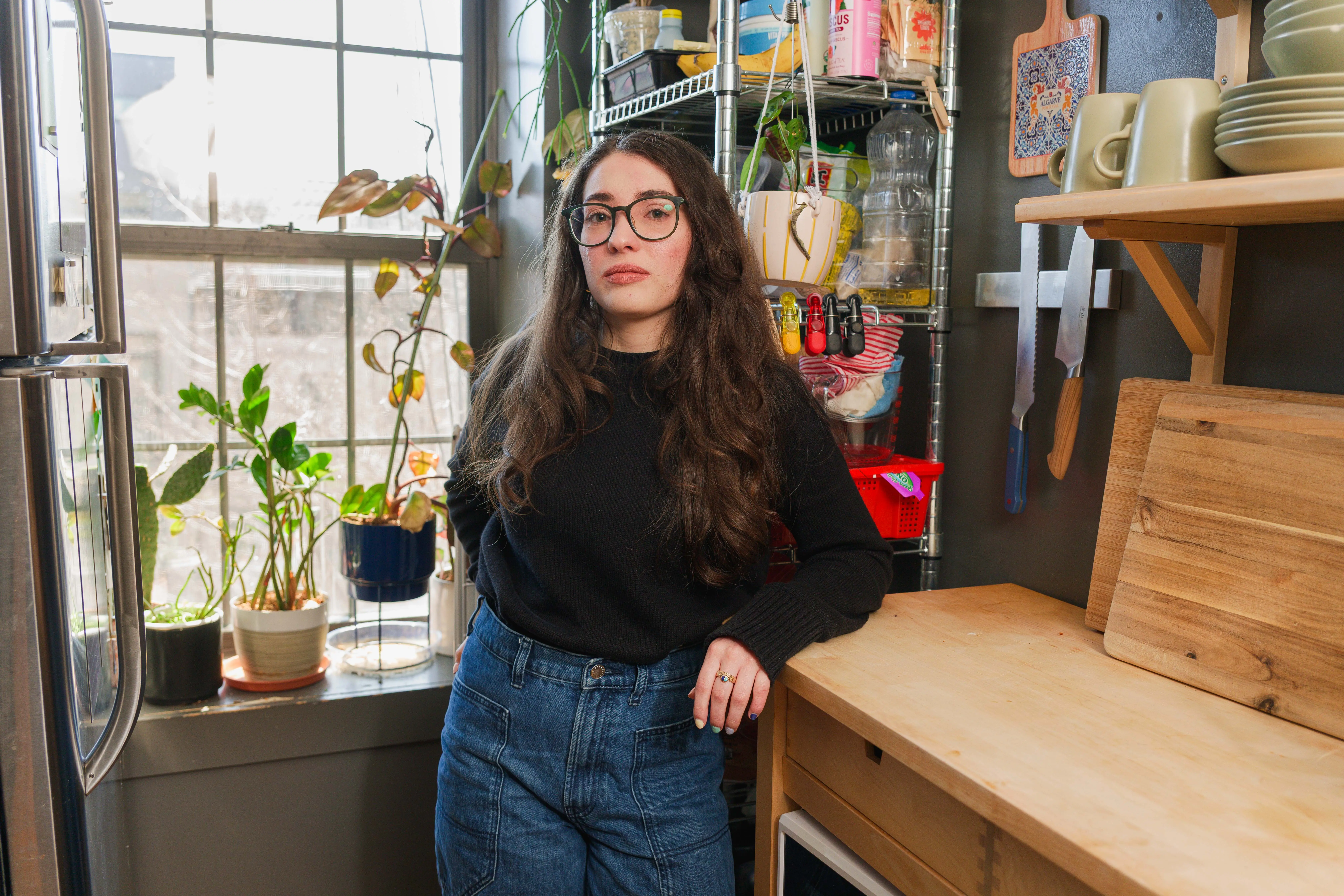 Dove Williams standing in her NYC kitchen that her parents pay for