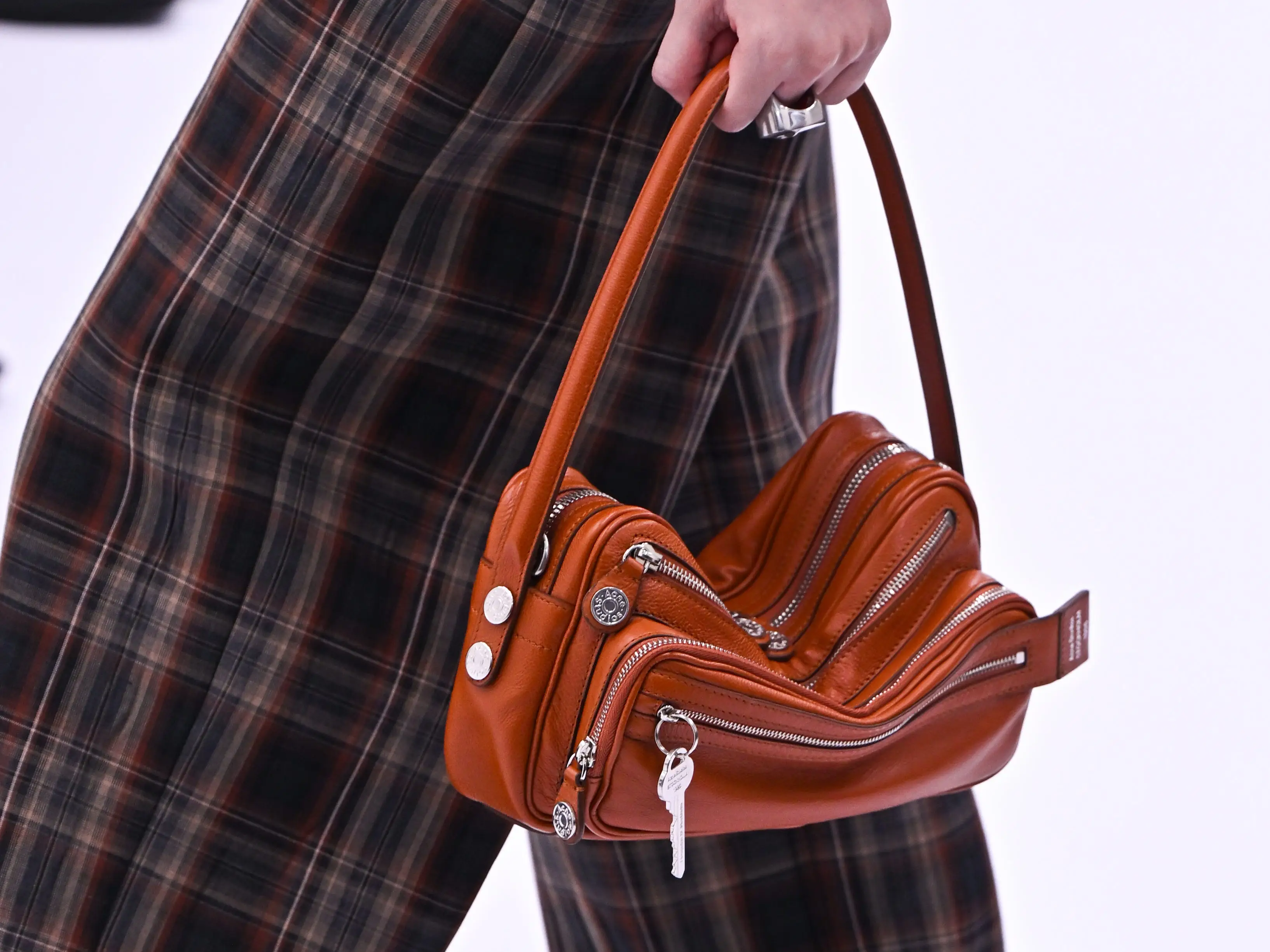 A model carries a Camero bag from Acne Studios on a 2024 runway.