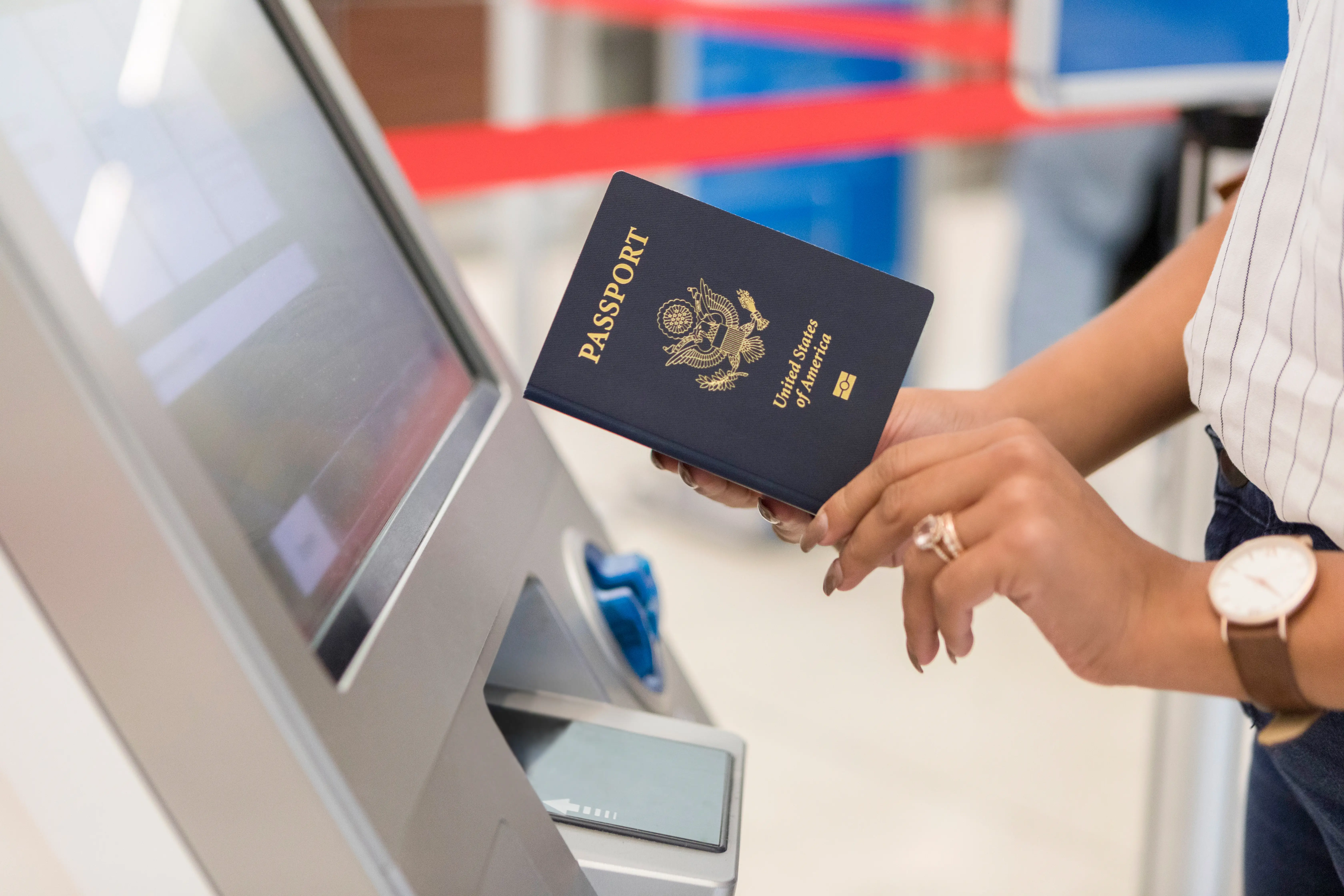 A person holding a passport from USA checks in at an airport.