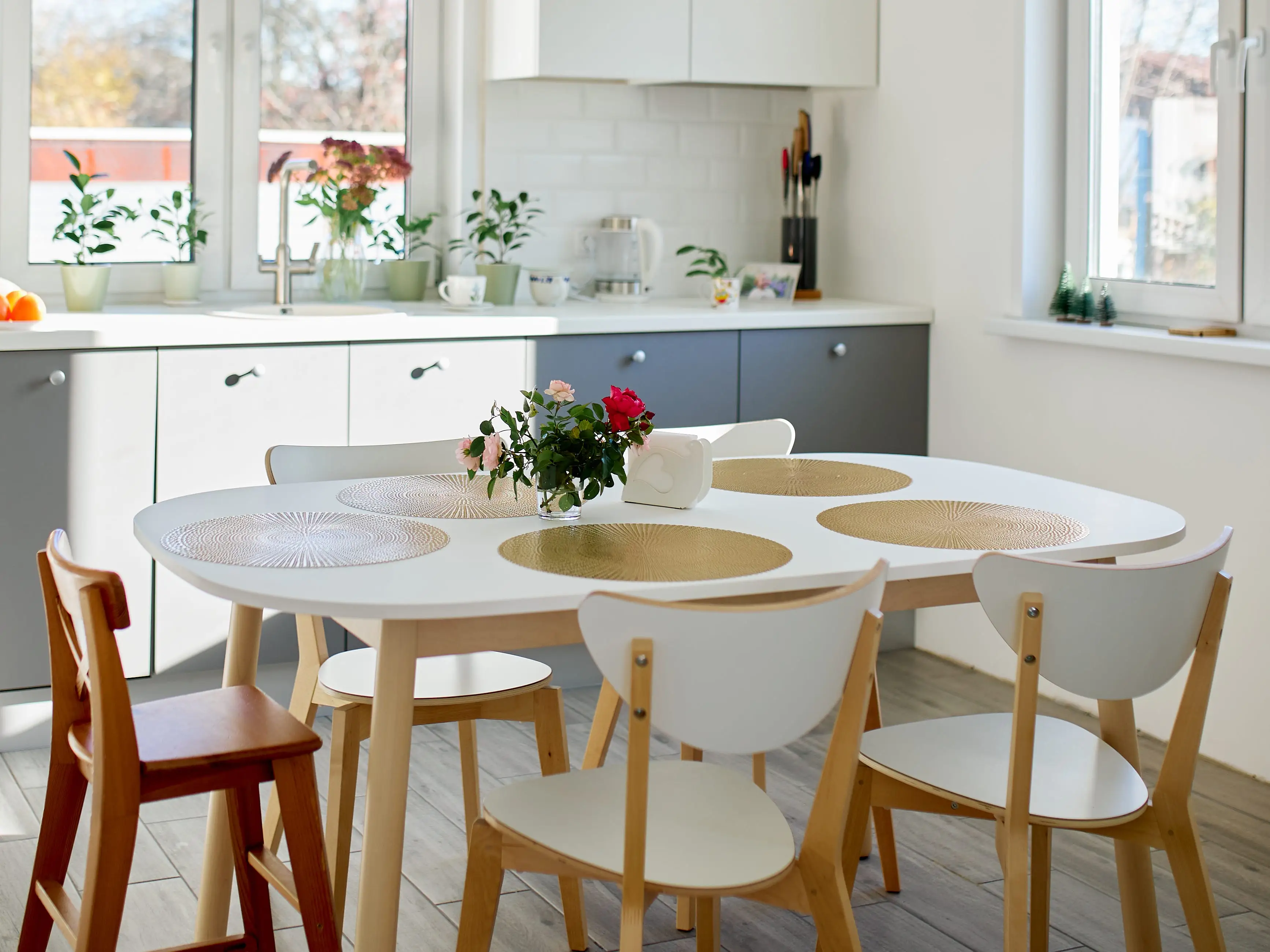 A kitchen table with chairs and placemats.