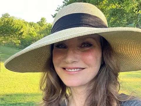 A woman wearing a sun hat.