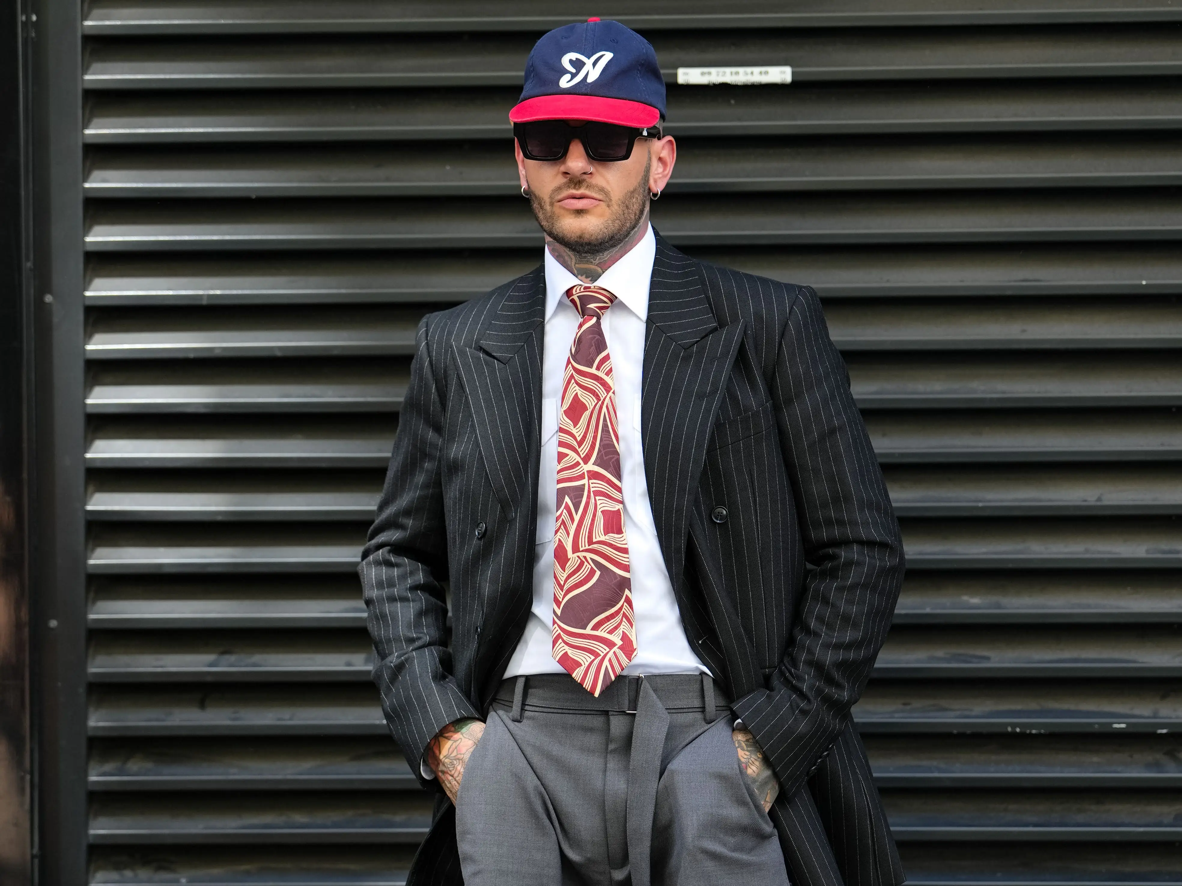 A man wears an Aimé Leon Dore hat in Paris.