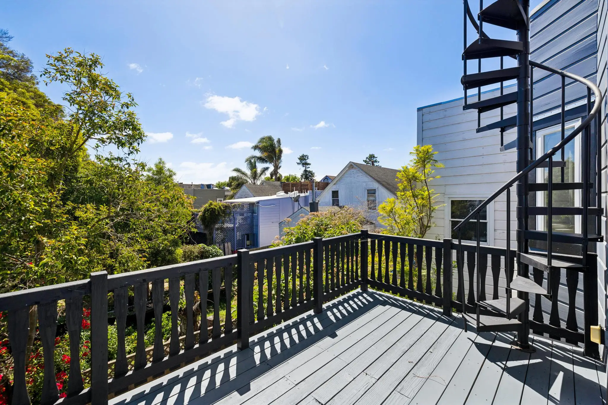 An outdoor deck overlooks a shared garden and offers views of nature in San Francisco.