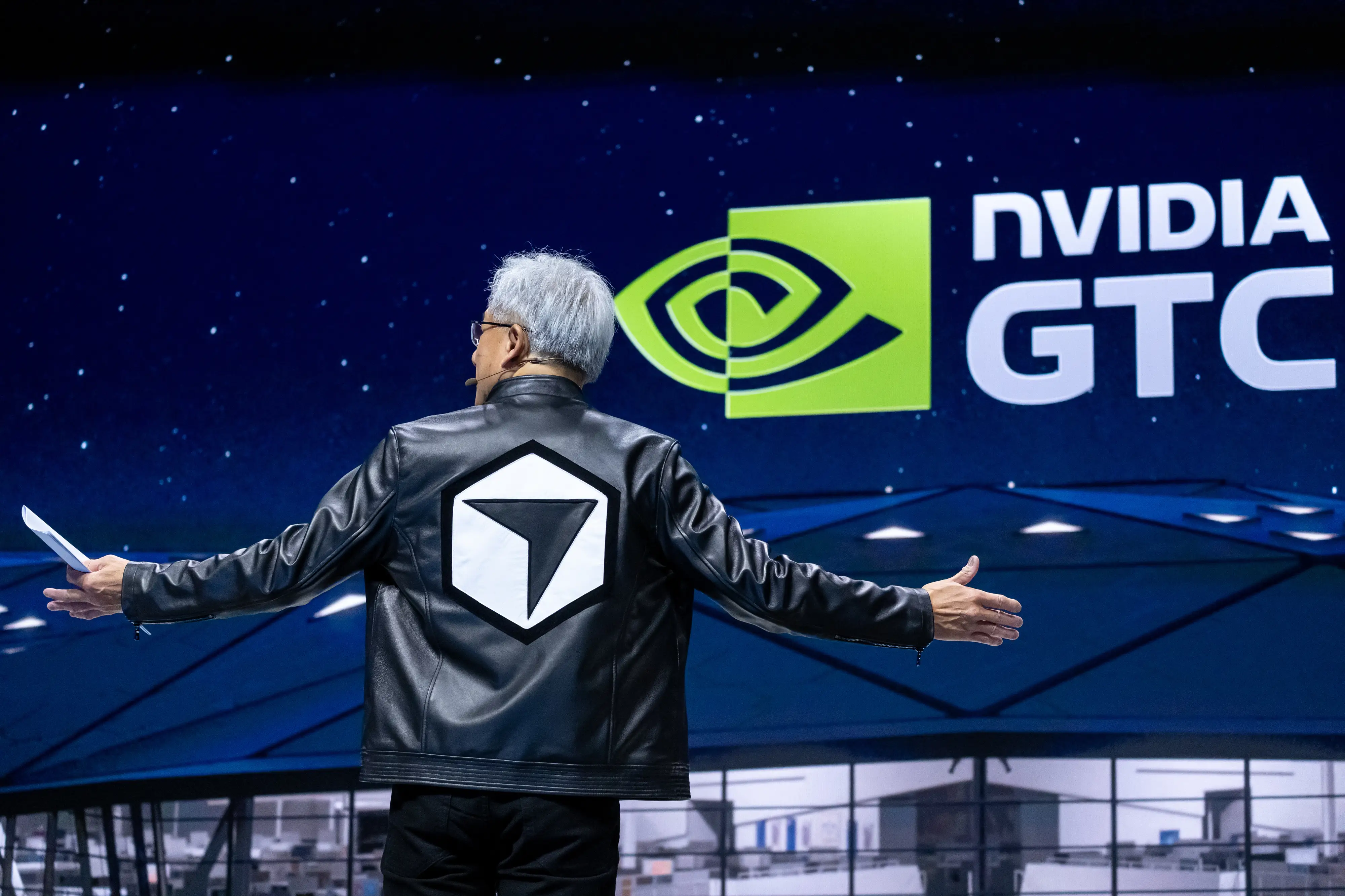 Jensen Huang sports a leather jacket with a Cursor logo.