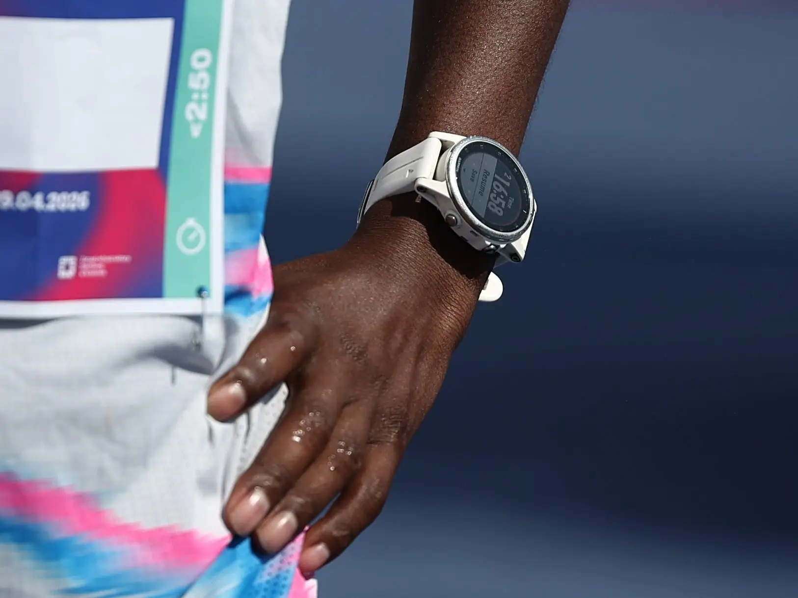 An athlete wears a Garmin watch.