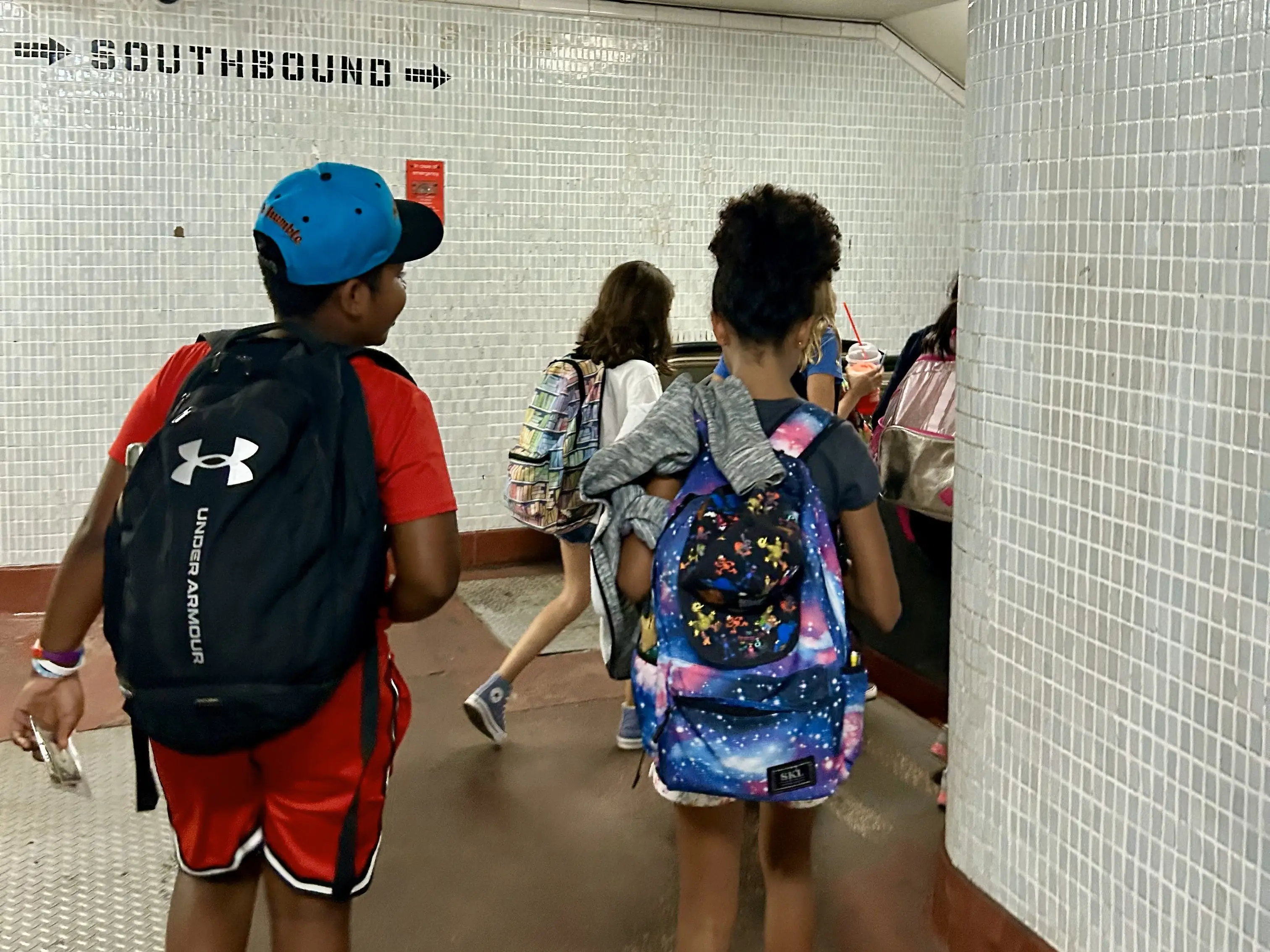 Kids walking through the subway
