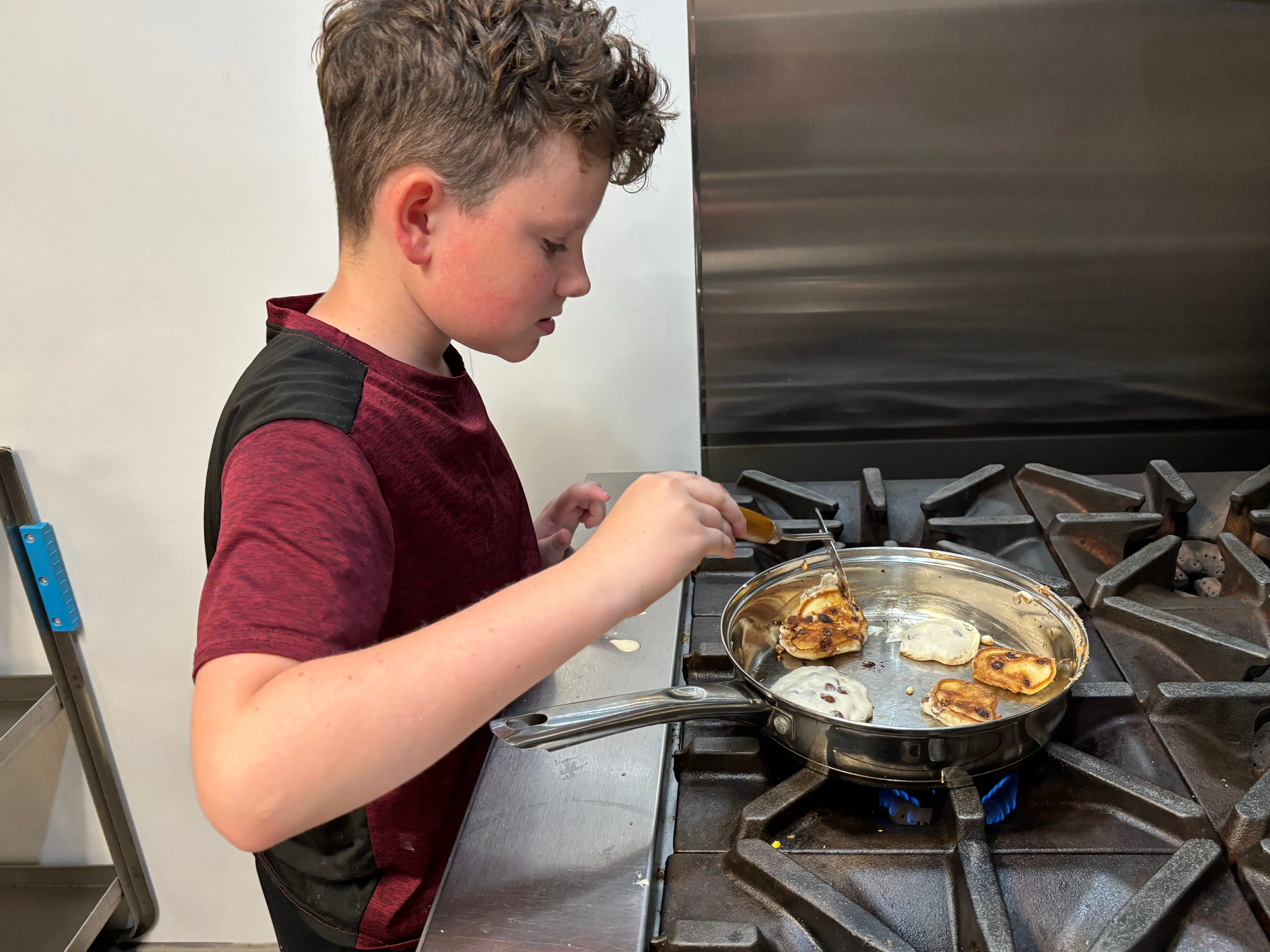 A boy making pancakes