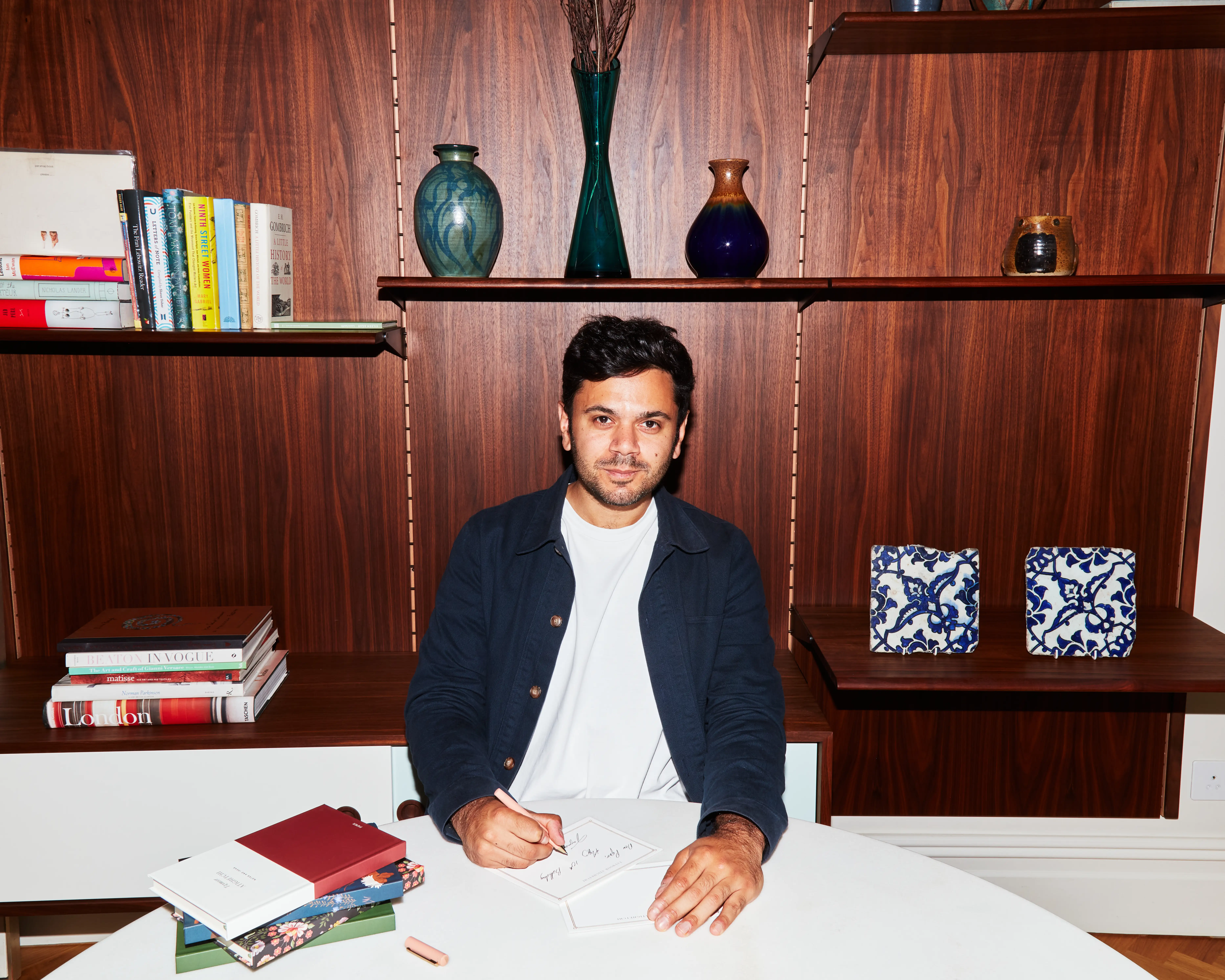 Taymoor Atighetchi, founder and CEO of Papier, writes on a notecard while sitting down.