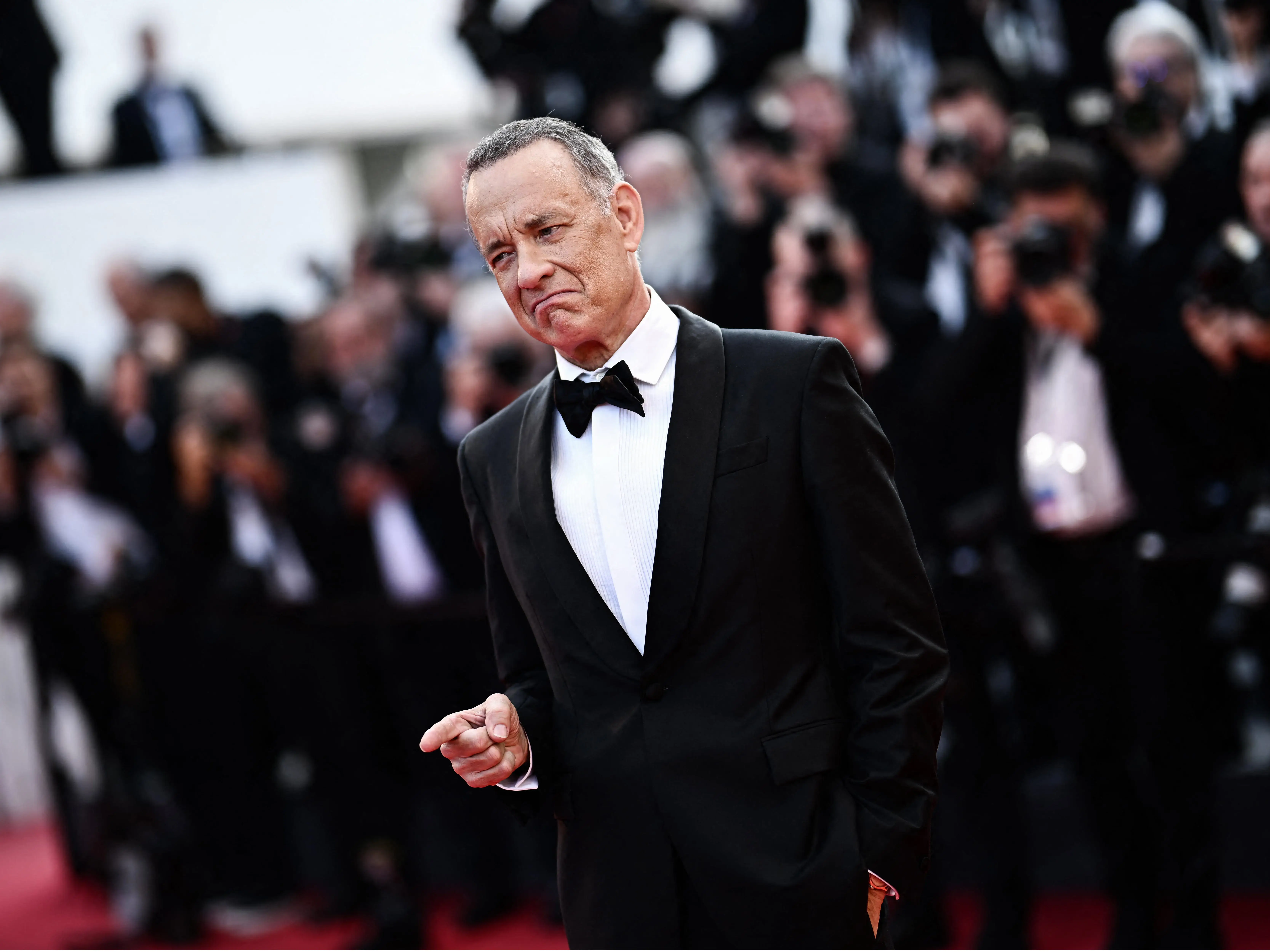 Tom Hanks points his finger at the Cannes Film Festival.