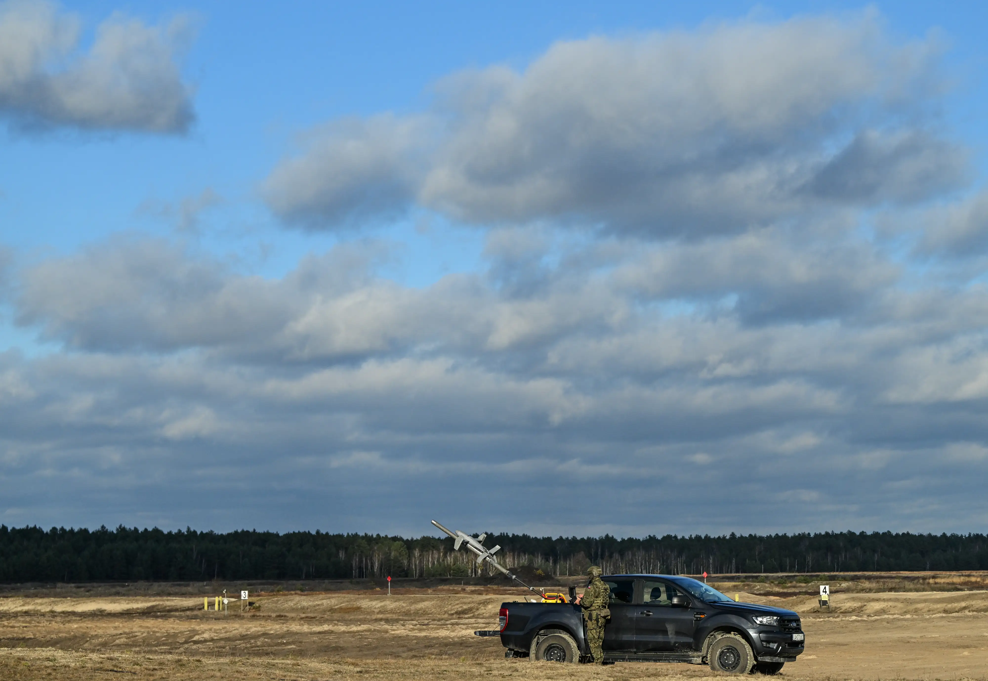 A Polish Army soldier launches an AS3 Surveyor interceptor drone, part of the MEROPS US counter-drone system, during a live-fire demonstration at the Deba training grounds in Subcarpathian Voivodeship, Poland, on November 18, 2025.
