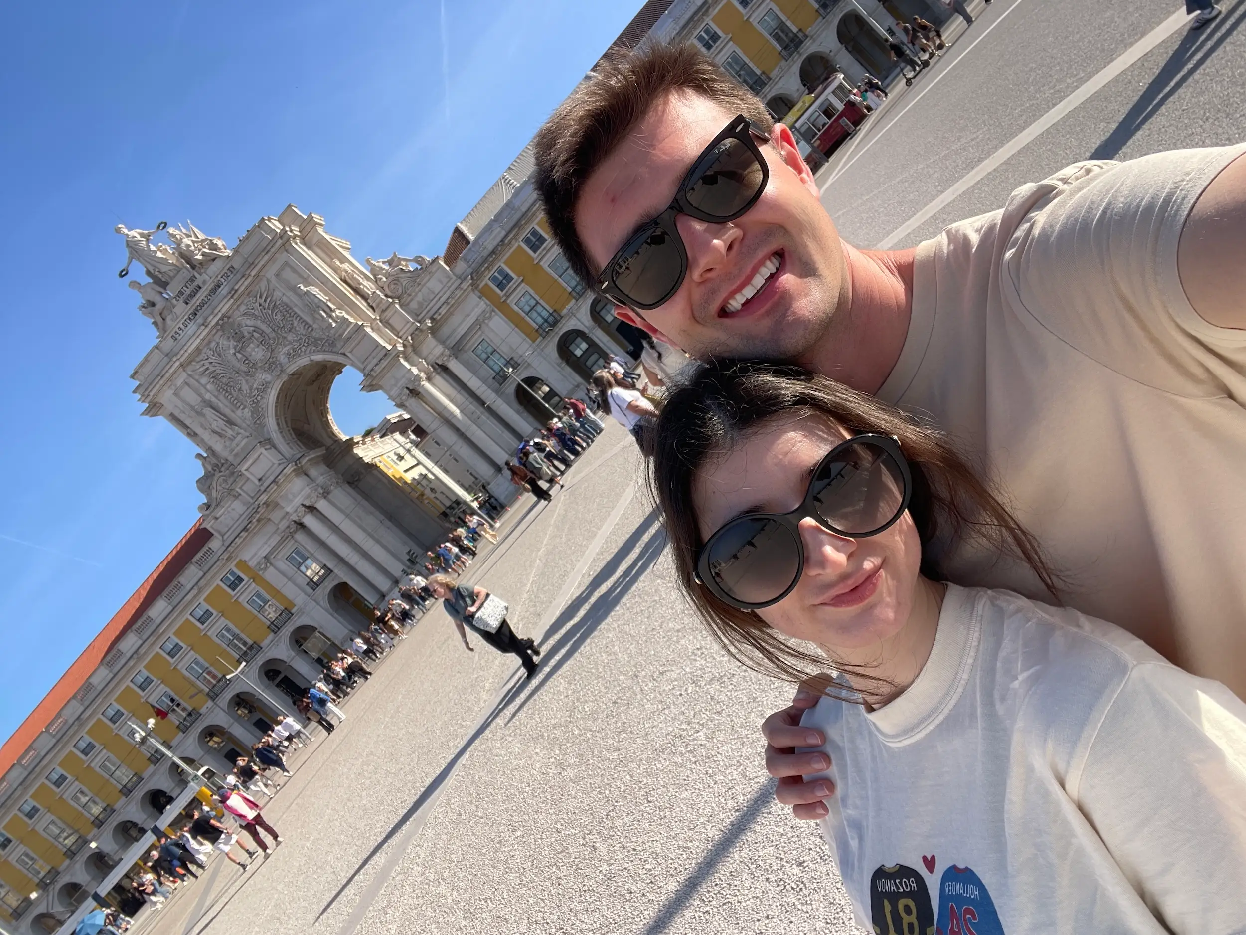 A man and woman at the Arco da Rua Augusta in Portugal.