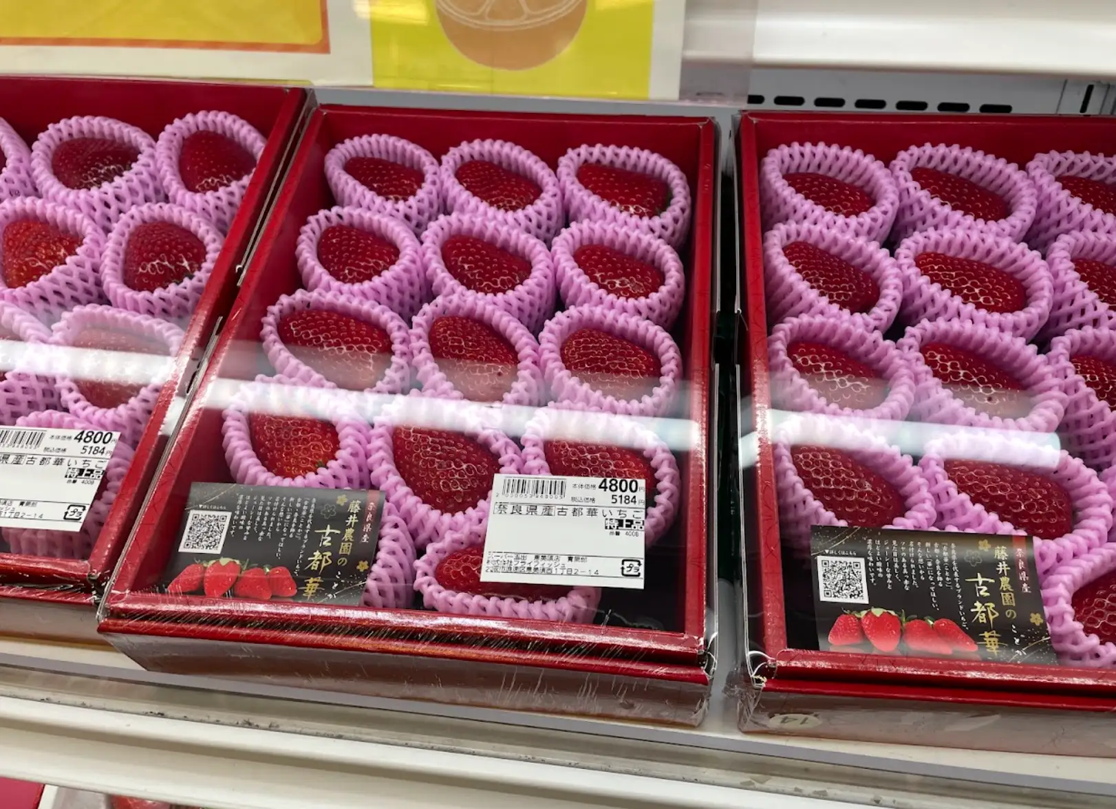 Rows of strawberries at a grocery store in Japan.