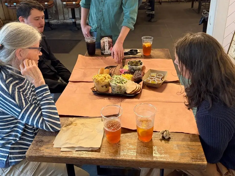 Barbecue being served on paper-covered table